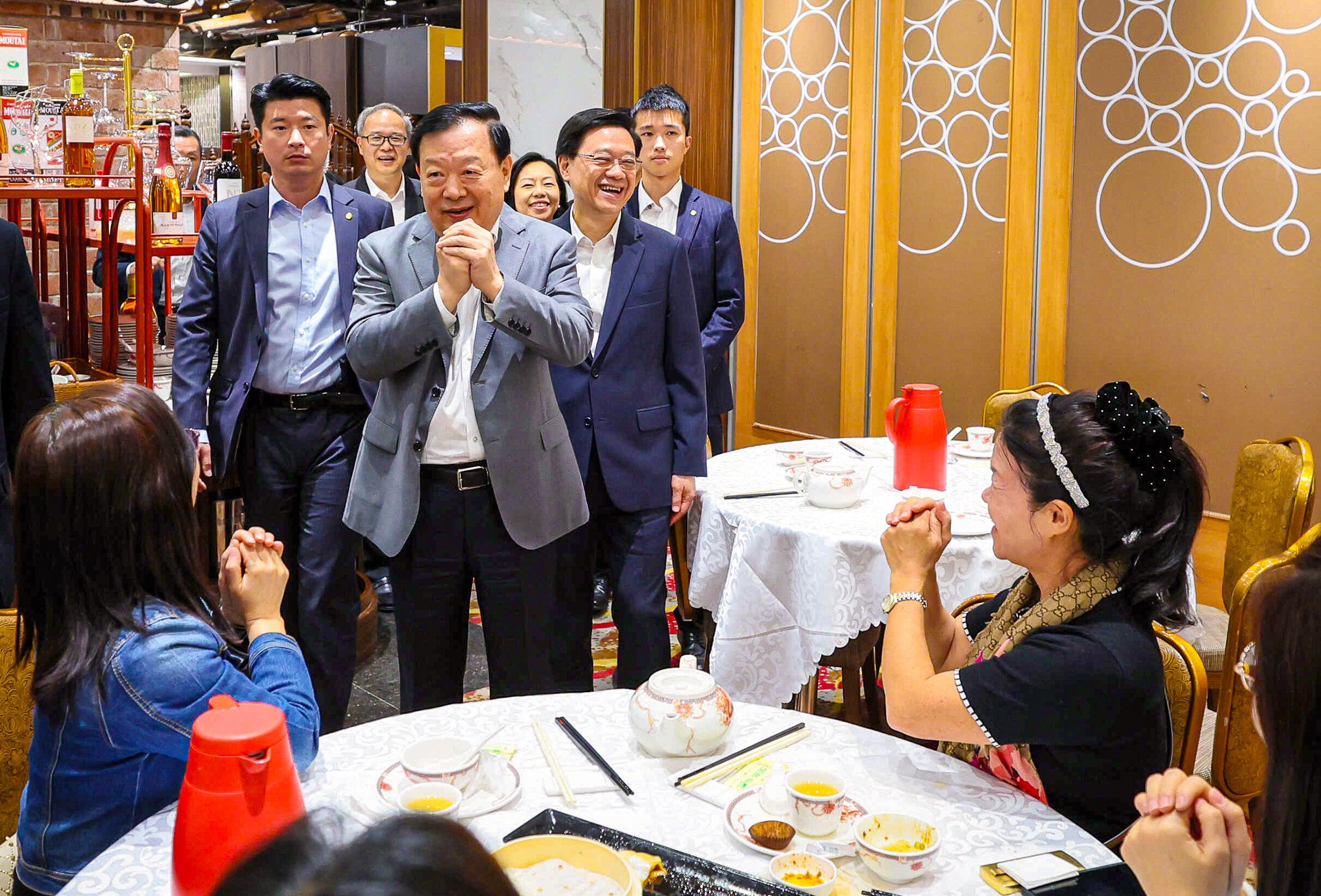 Xia Baolong (centre), accompanied by Chief Executive John Lee, meets district representatives at a restaurant in Tseung Kwan O during his last visit. Photo: HKMAO