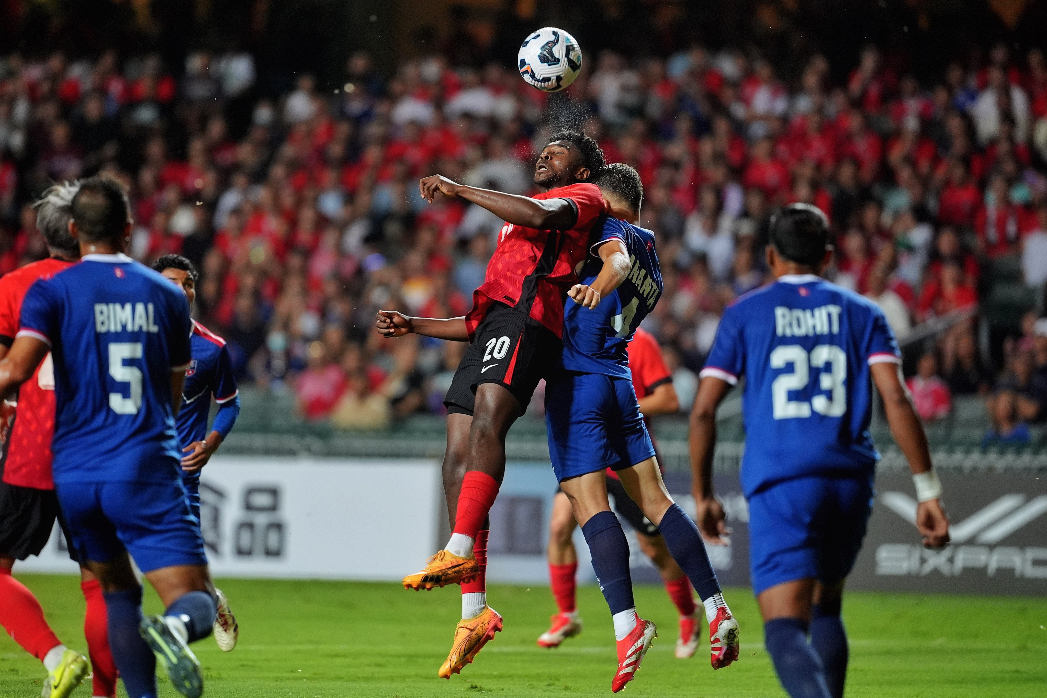 Michael Udebuluzor leaps to win a header during Hong Kong’s stalemate with Nepal. Photo: Elson Li