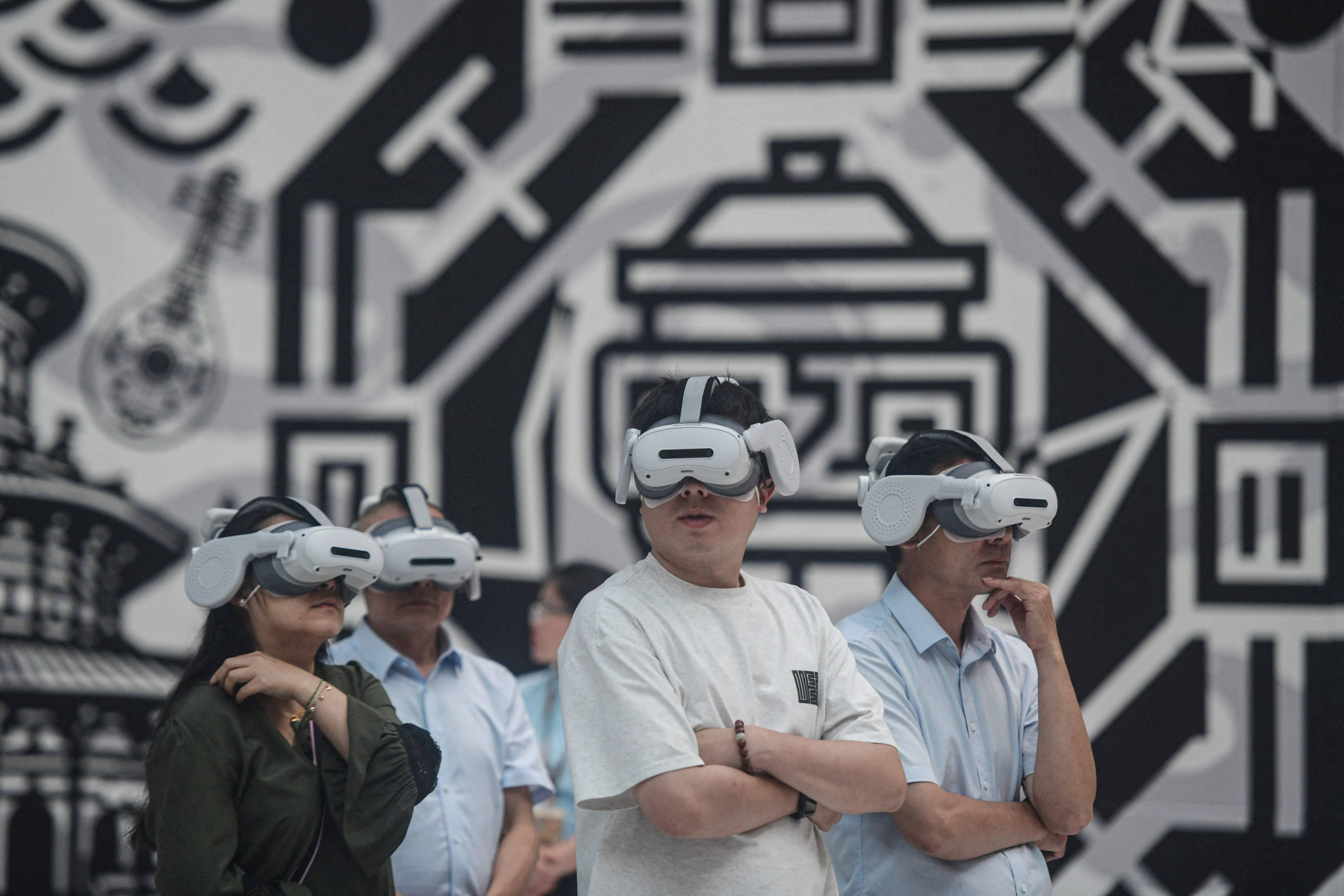 People wearing virtual reality goggles experience an immersive virtual exhibition recreating life during the Tang dynasty at the Hangzhou International Expo Centre on Tuesday. Photo: AFP