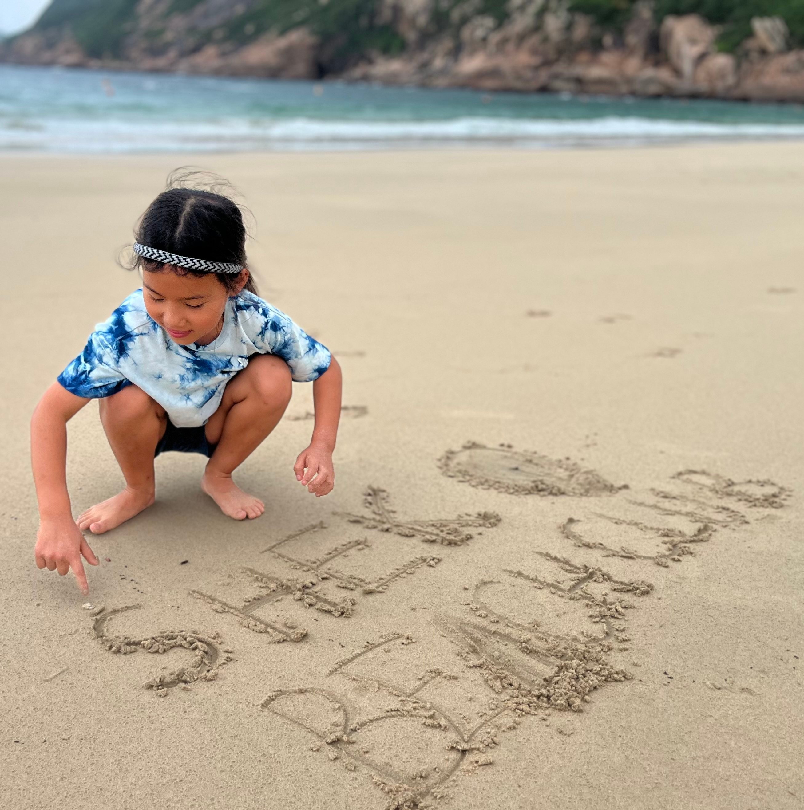 Emilia Li spells out the name of her fashion brand at Shek O Beach in Hong Kong. Photo: Kylie Knott