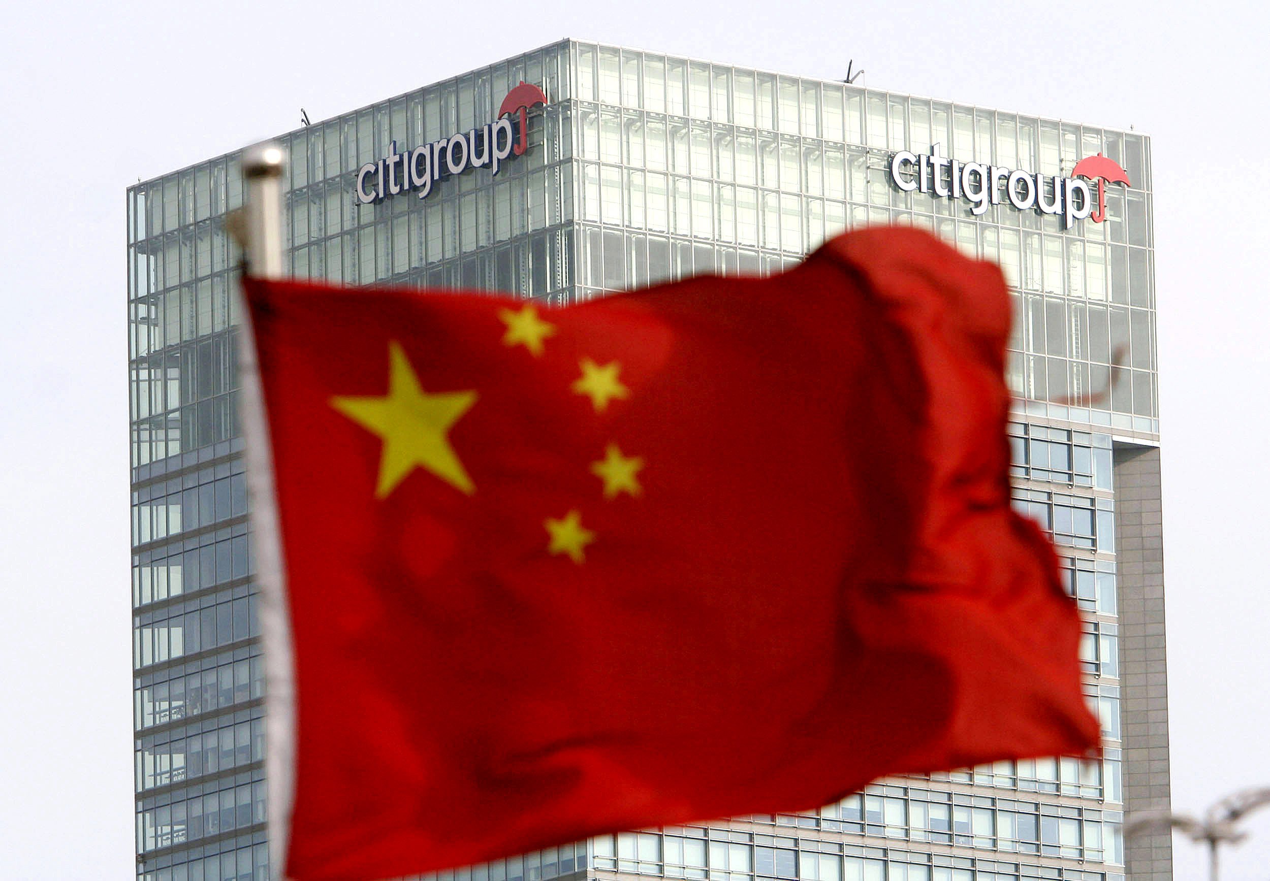 A Chinese national flag is hoisted near the Citigroup Tower in Shanghai. Photo: AP