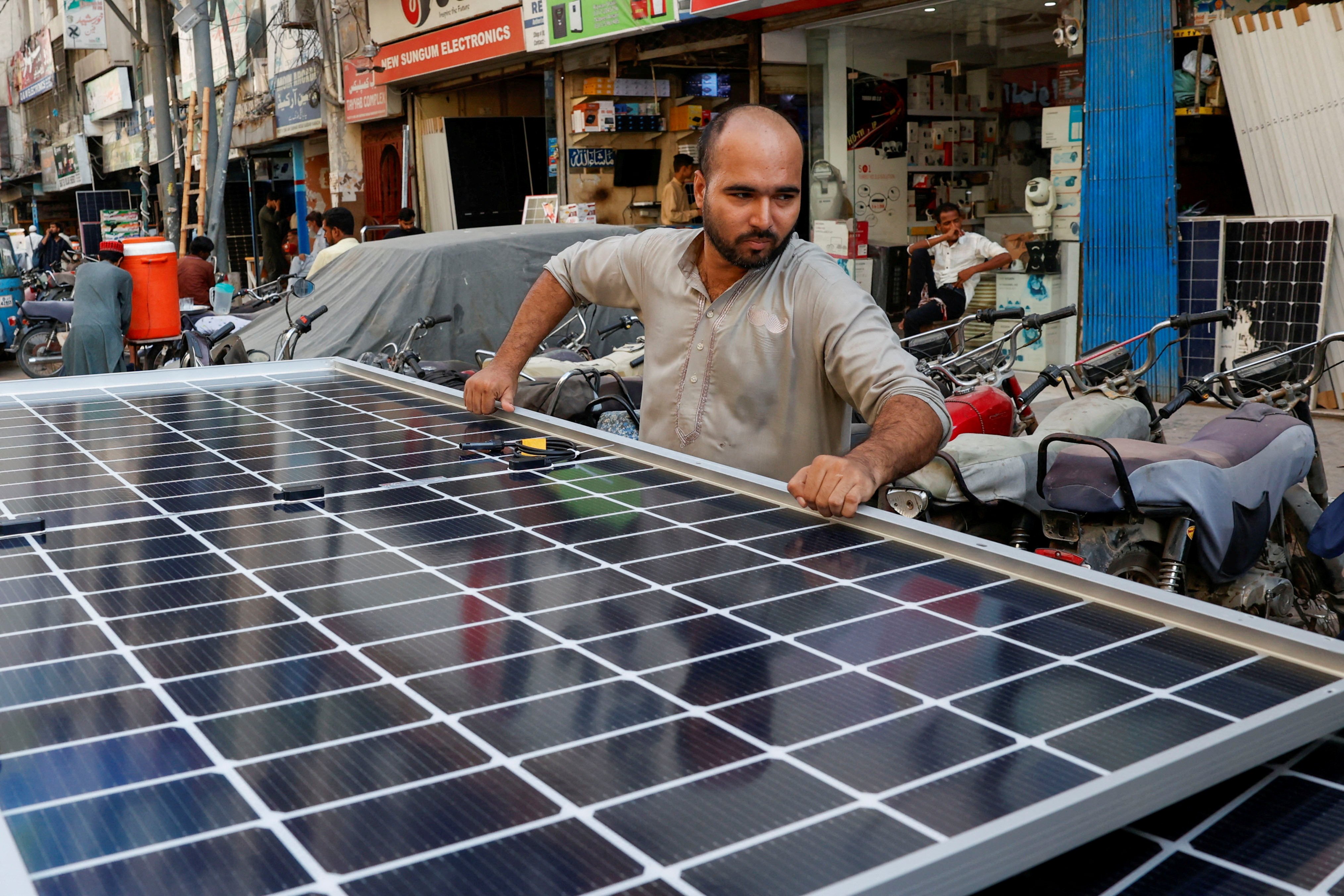 A solar panel is loaded onto a vehicle at a market in Karachi, Pakistan, in June last year. Photo: Reuters