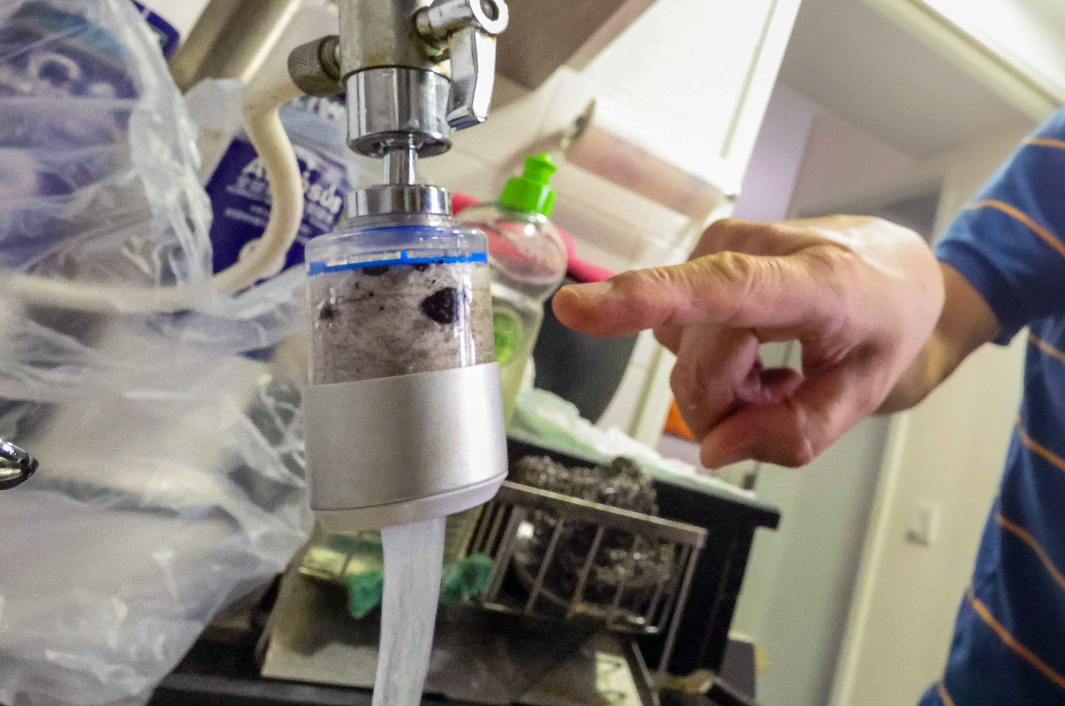 Residents of two Hong Kong public estates have started buying bottled water after finding black particles in their freshwater supply. Photo: Dickson Lee
