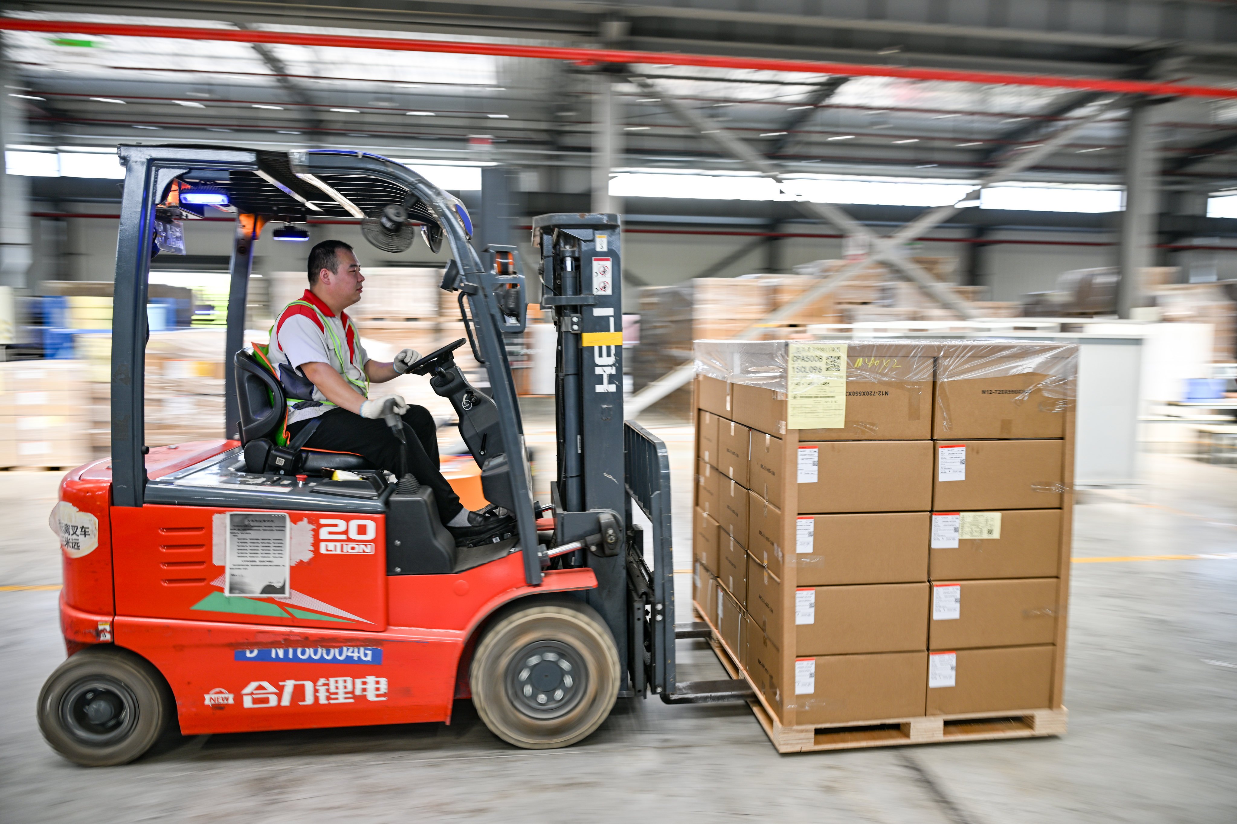 A worker moves car parts destined for export at a GWM factory in Chongqing on May 21. Photo: Xinhua