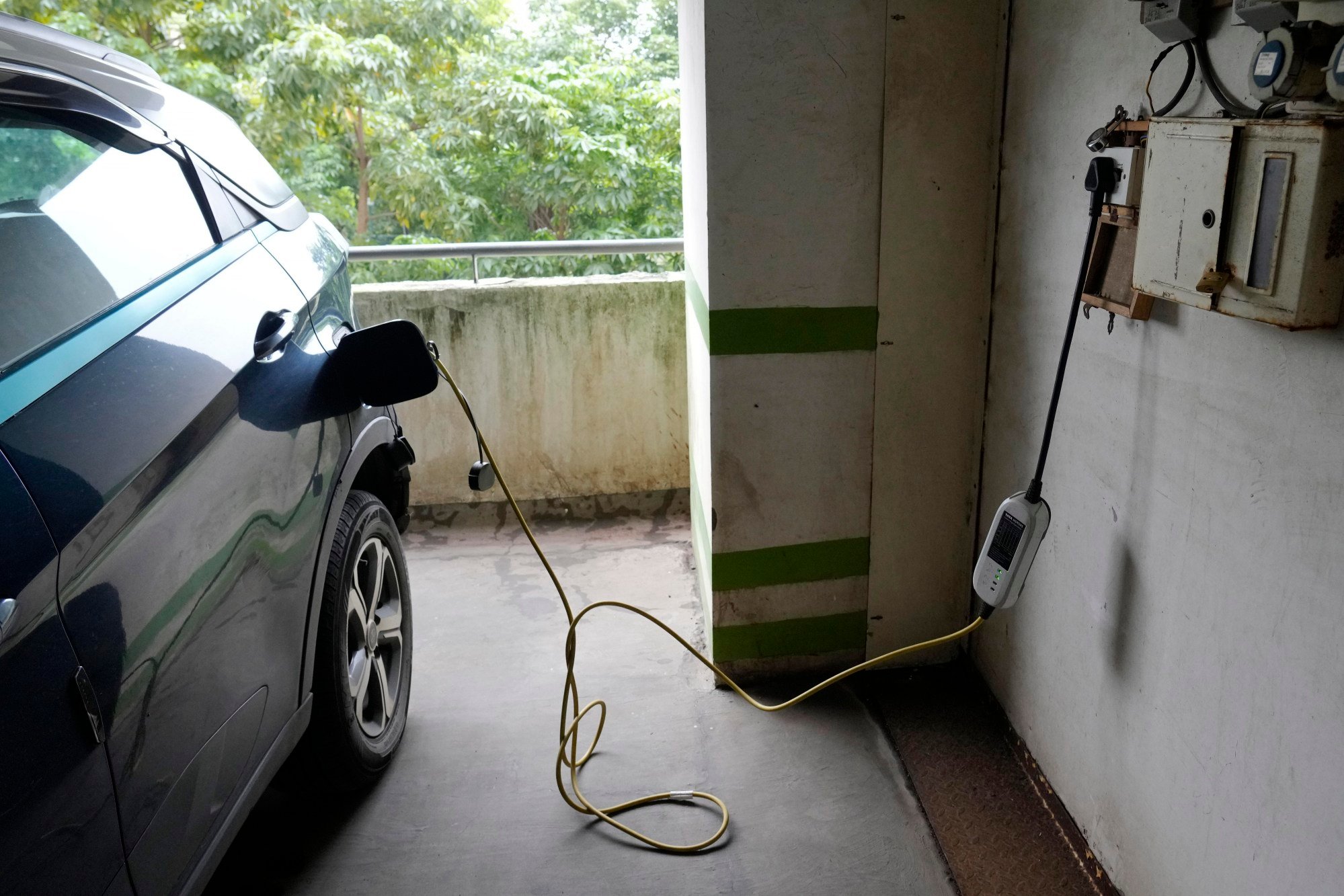 A car gets charged at an electric vehicle charging station at a residential building car park in Mumbai, India, in July 2024. Photo: AP A car gets charged at an electric vehicle charging station at a residential building car park in Mumbai, India, in July 2024. Photo: AP