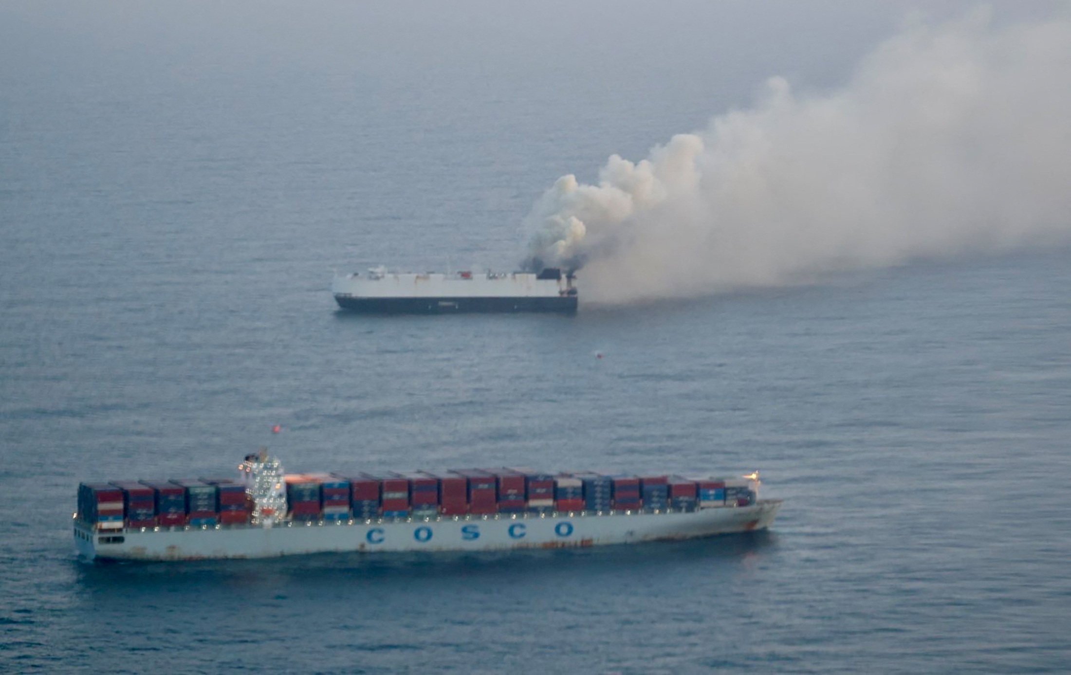 Smoke rises from the Morning Midas, which was carrying around 3,000 vehicles. Photo: US Coast Guard via Reuters