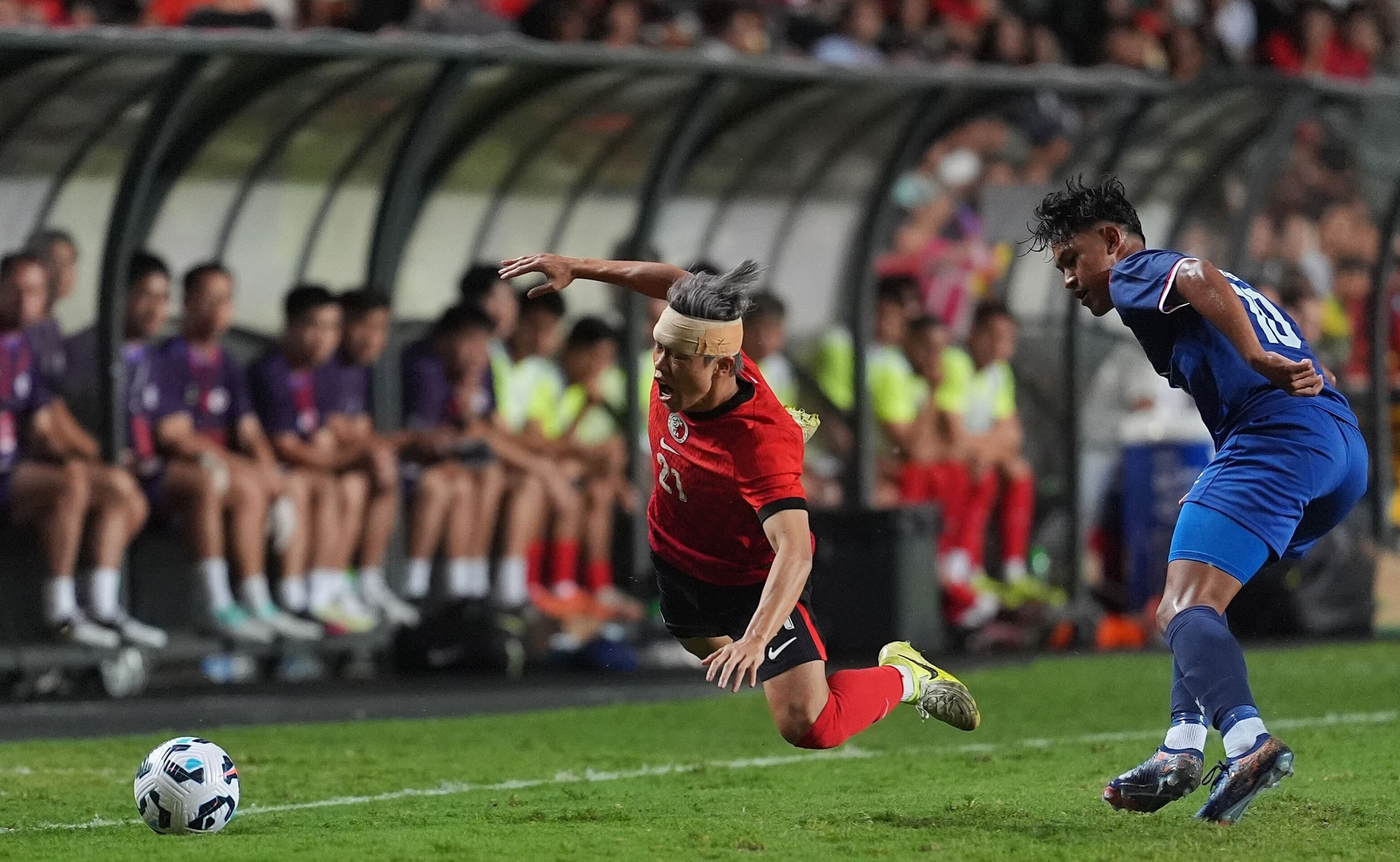 A bandaged Yue Tze-nam is sent flying during Hong Kong’s draw with Nepal. Photo: Elson Li
