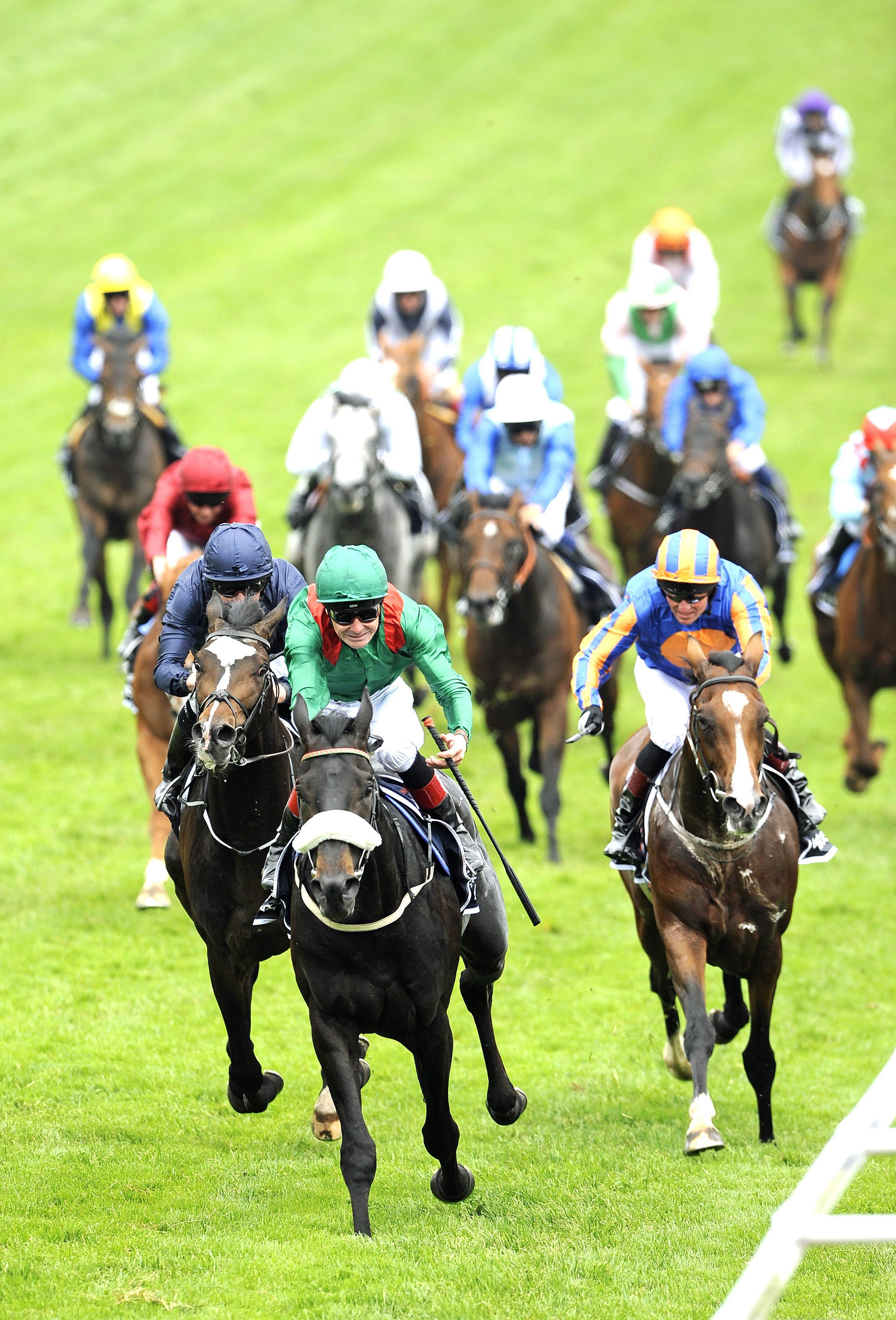 Harzand (centre) wins the 2016 Epsom Derby for the Aga Khan. Photo: EPA
