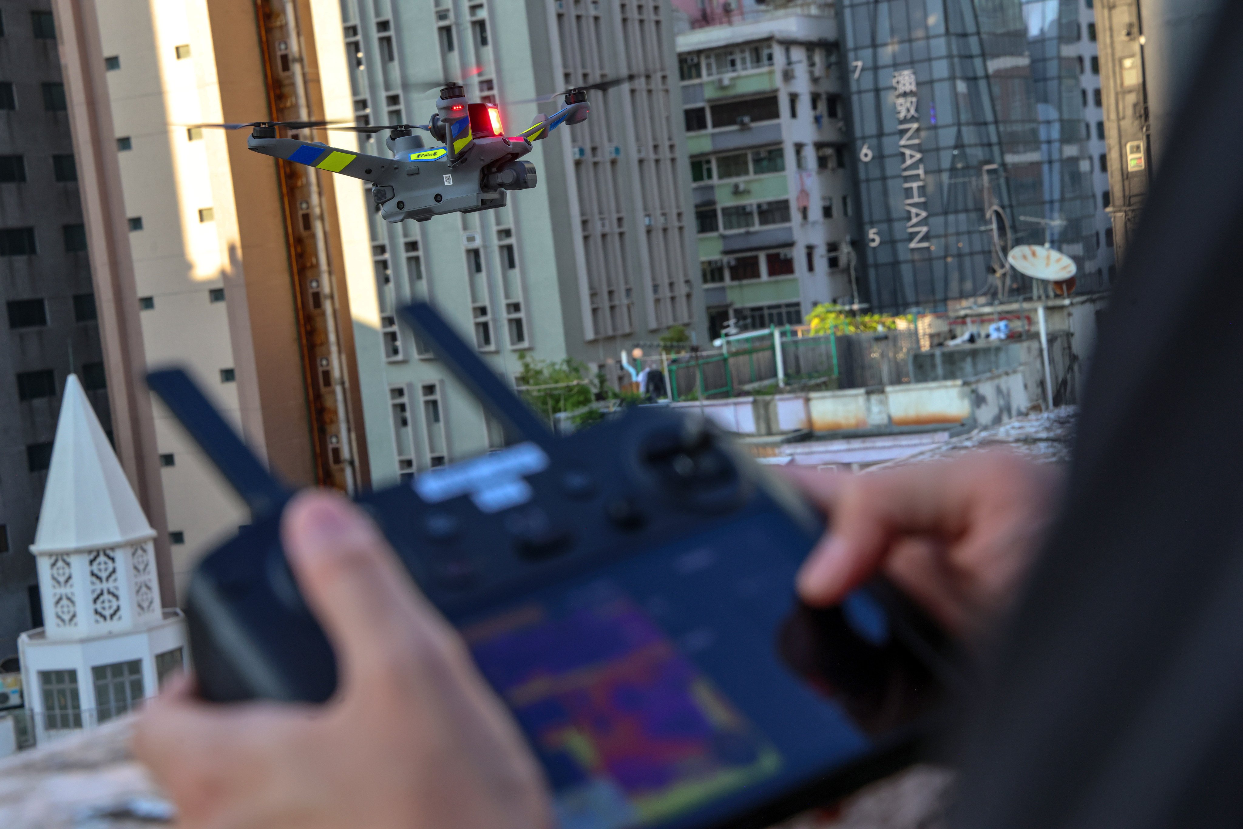 A police drone flies above the streets of Yau Ma Tei on Friday. Photo: Jelly Tse