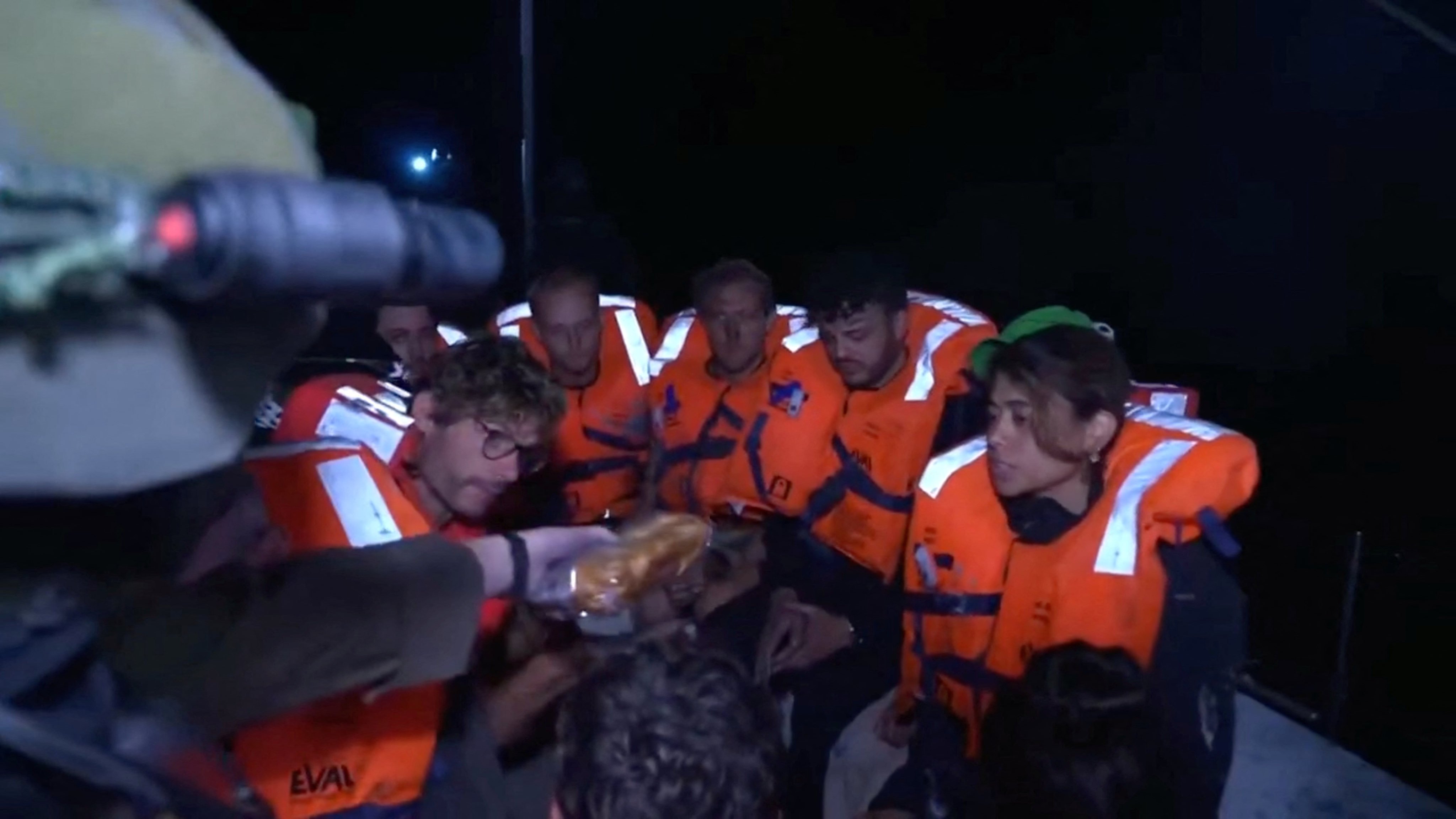 An Israeli solider passes food to those onboard the Gaza-bound British-flagged yacht Madleen. Photo: Israel Foreign Ministry via X