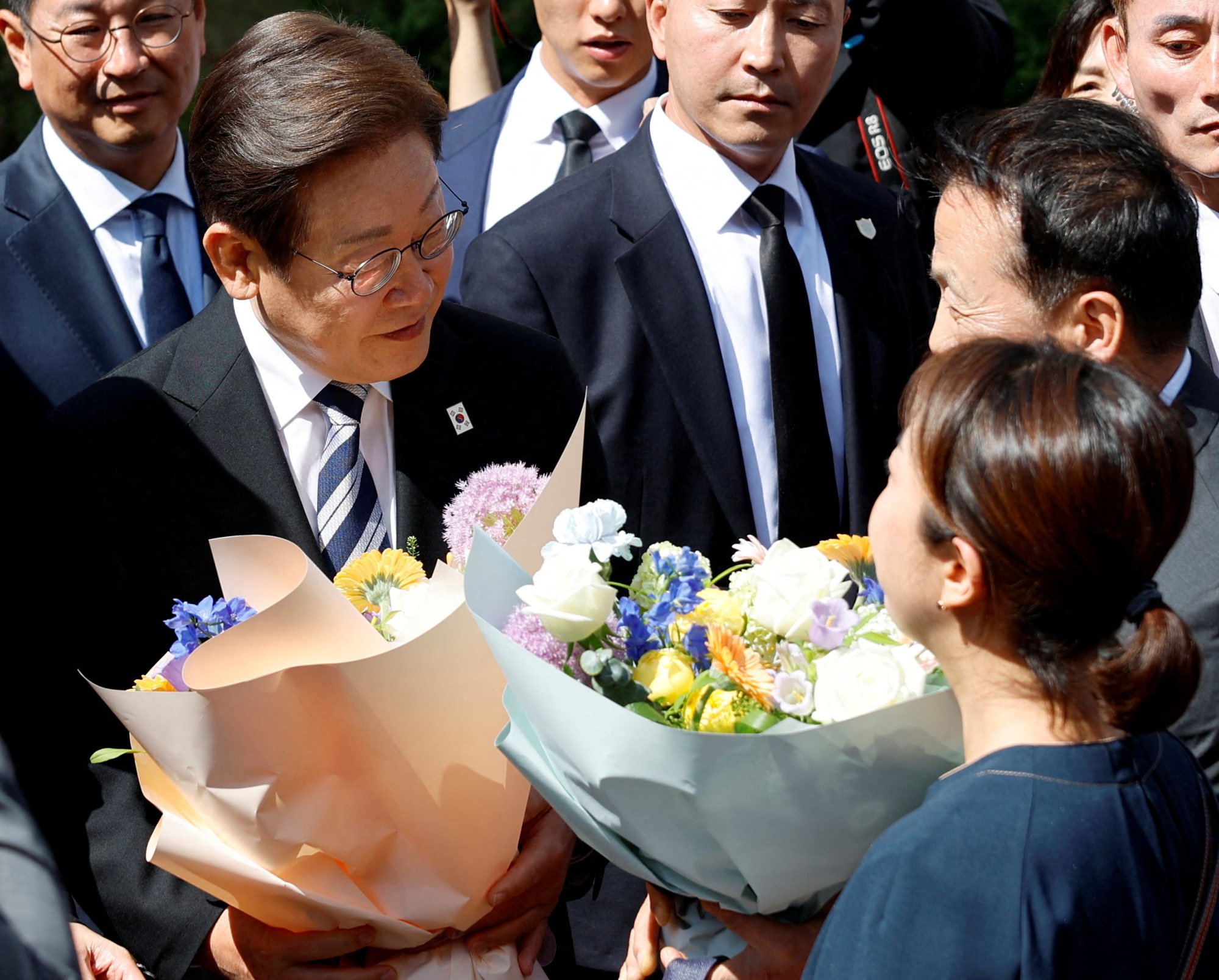 Supporters hand flowers to President Lee Jae-myung as he departs for the National Assembly to attend his inauguration ceremony on Wednesday. Photo: Reuters Supporters hand flowers to President Lee Jae-myung as he departs for the National Assembly to attend his inauguration ceremony on Wednesday. Photo: Reuters