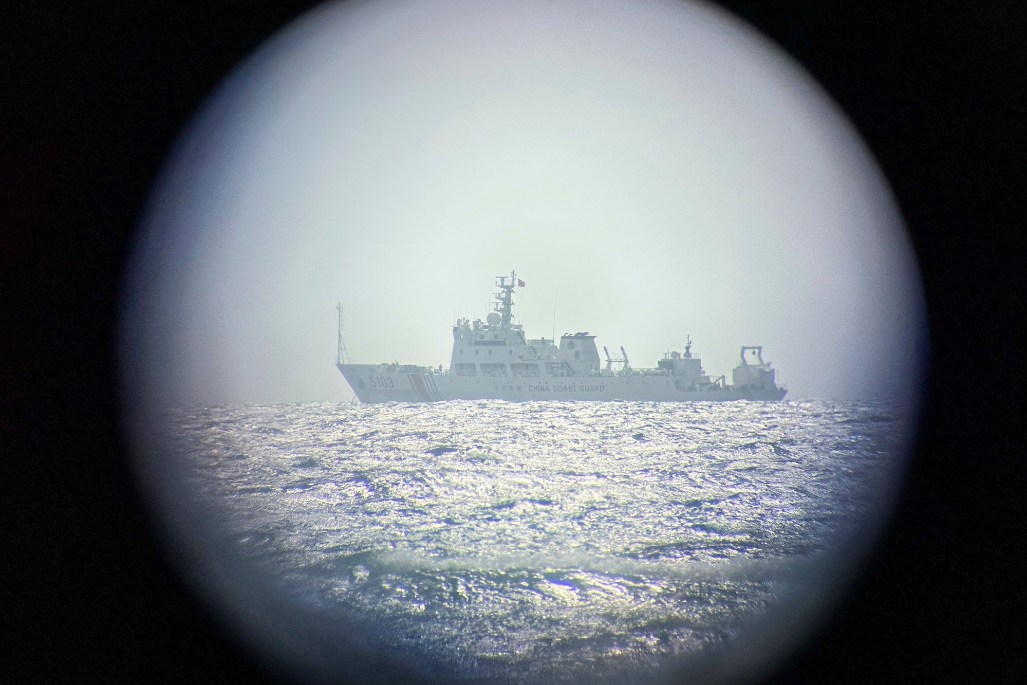 A Chinese vessel is seen through binoculars from a Philippine-occupied island in the South China Sea on Wednesday. Photo: AP A Chinese vessel is seen through binoculars from a Philippine-occupied island in the South China Sea on Wednesday. Photo: AP