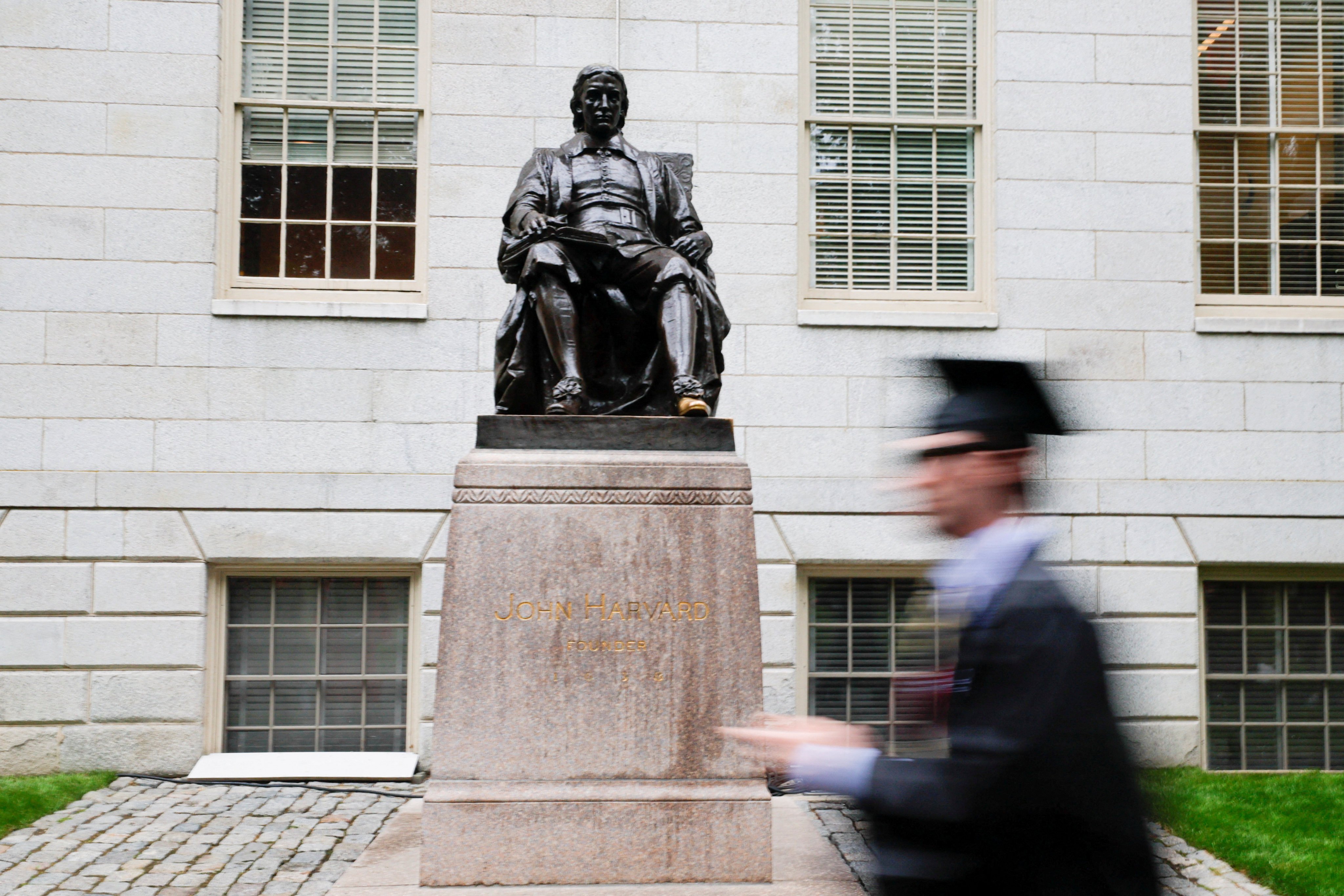 A student walks past the statue of John Harvard. US President Trump has sought to bar the entry of foreign nationals to Harvard University. Photo: Reuters