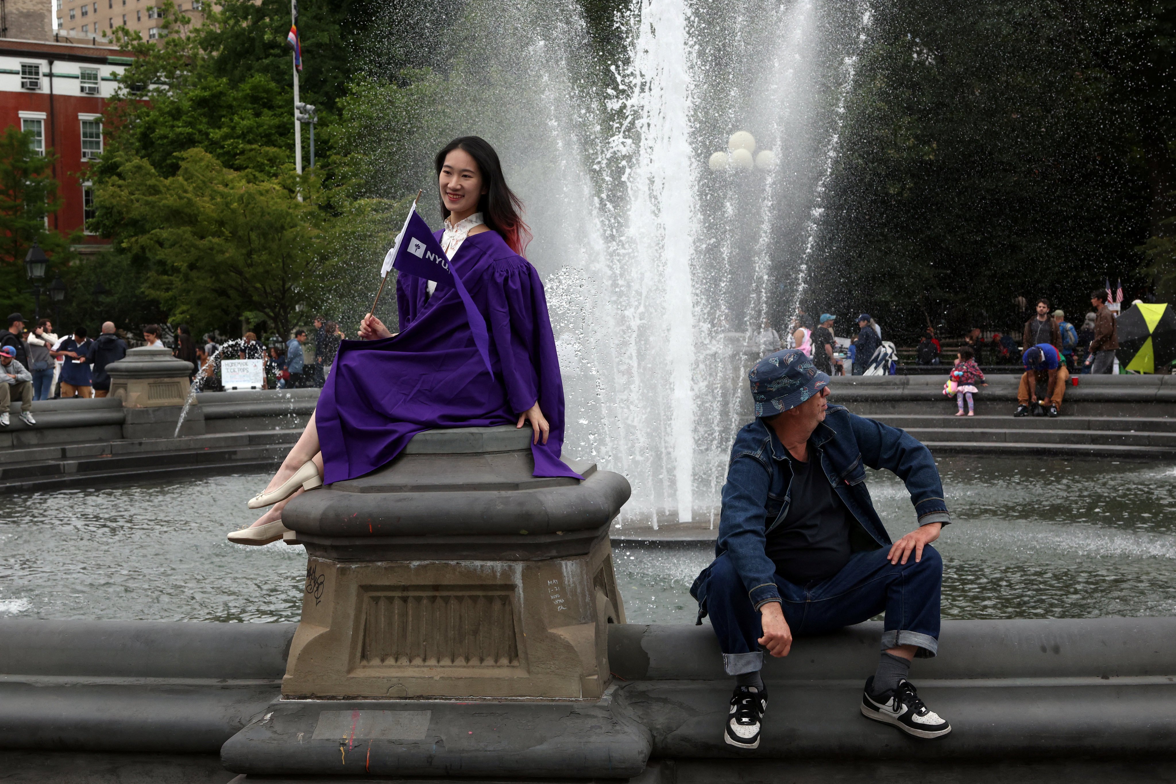 A Chinese university student poses for a graduation photo in New York City, on June 1. Photo: Reuters