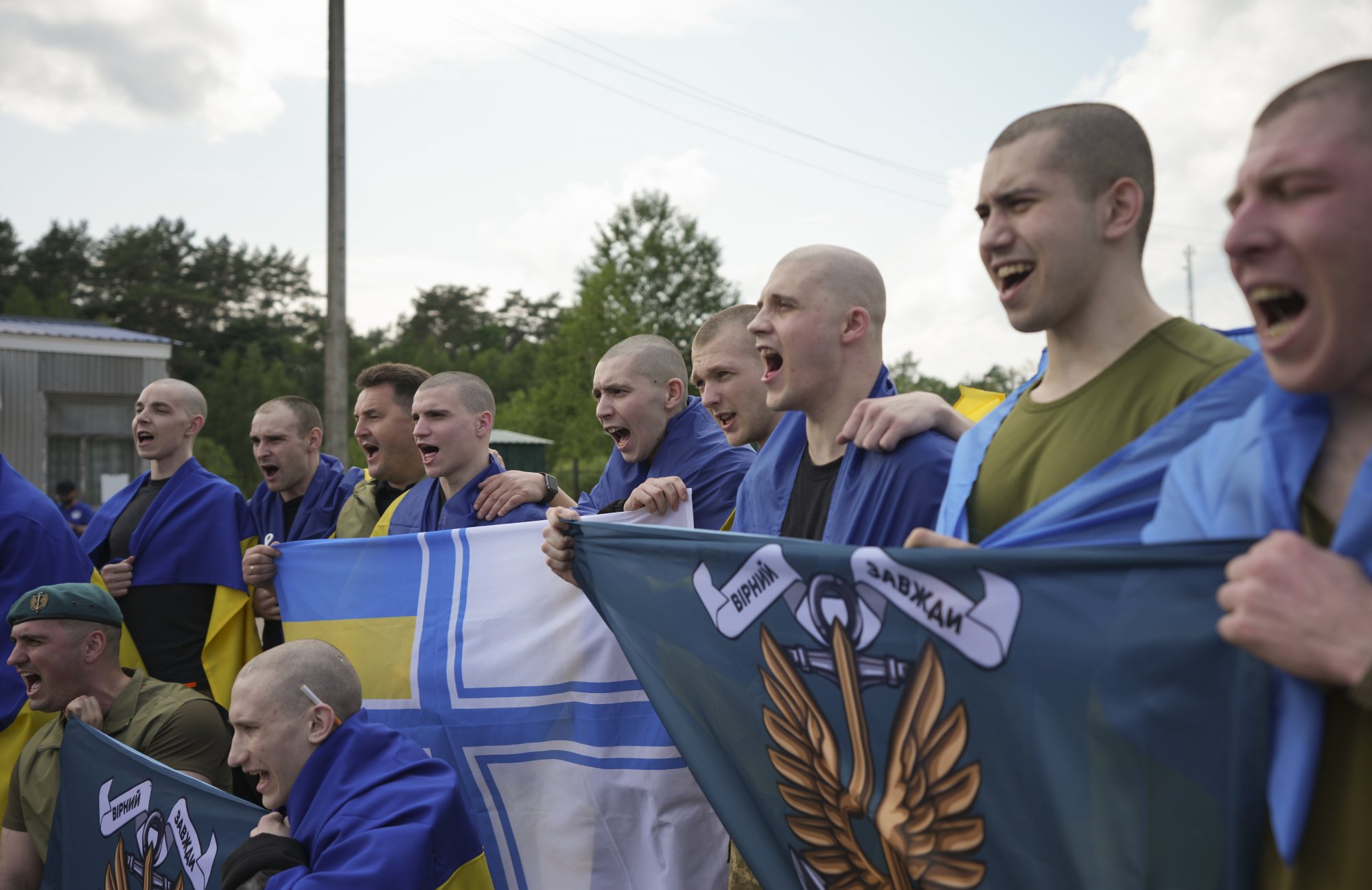 Ukrainian prisoners of war pose with flags following a prisoner swap with Russia, at an undisclosed location in Ukraine on Monday. Photo: EPA-EFE Ukrainian prisoners of war pose with flags following a prisoner swap with Russia, at an undisclosed location in Ukraine on Monday. Photo: EPA-EFE
