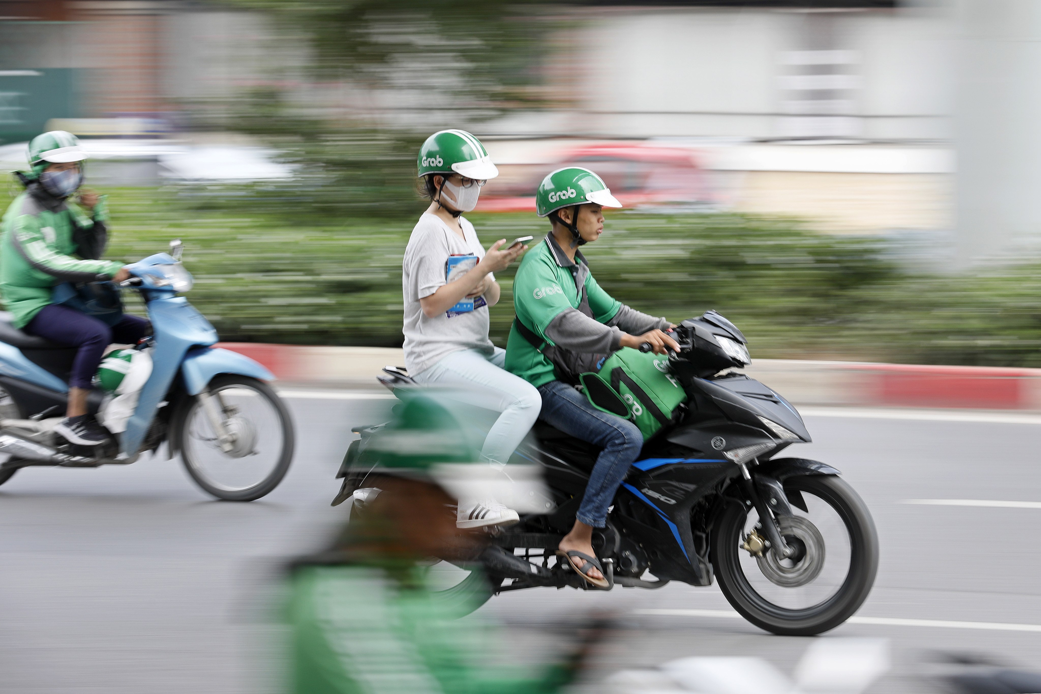 A GrabBike driver and his passenger in Hanoi on September 20, 2019. Photo: EPA-EFE