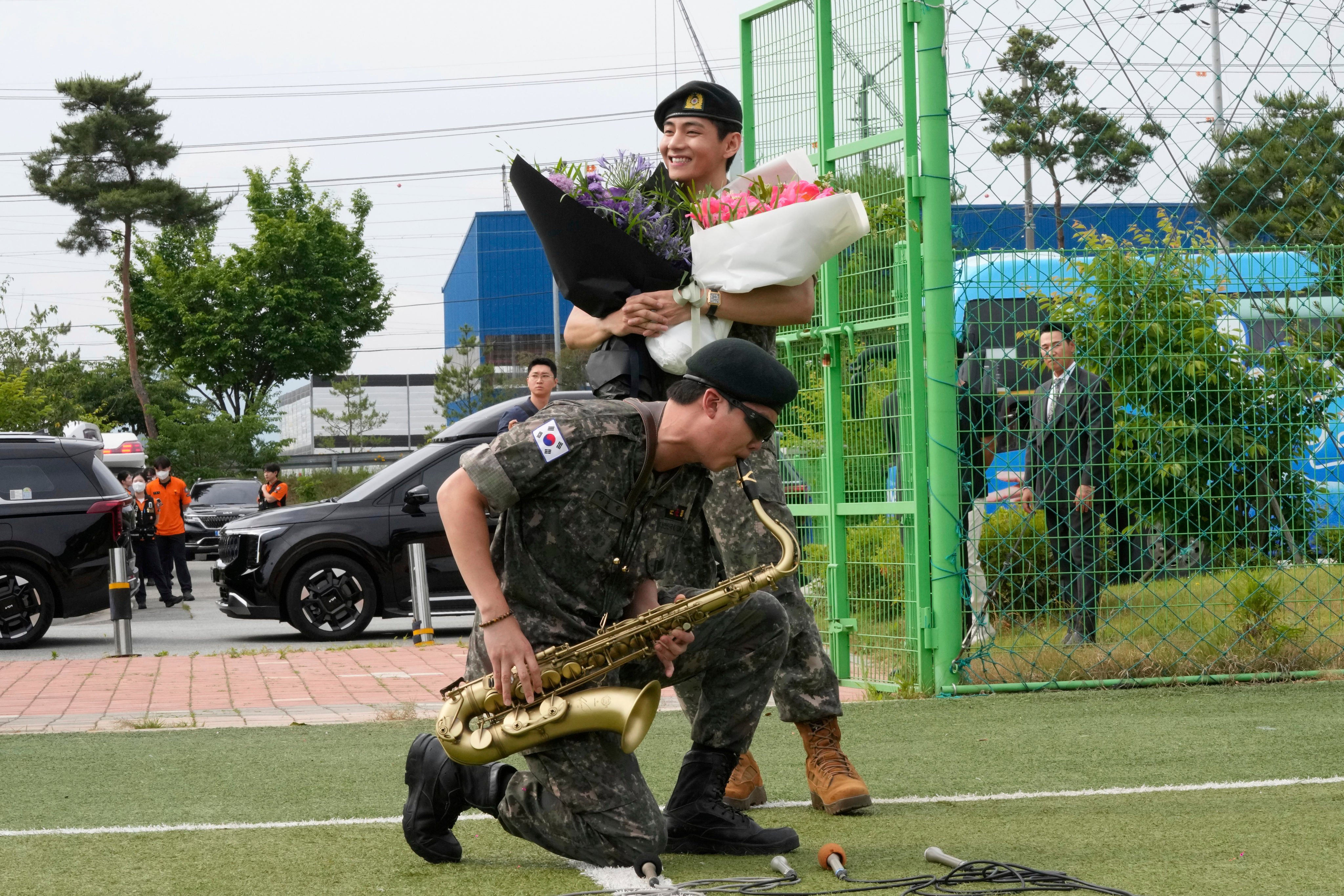 RM plays the saxophone alongside his bandmate V while meeting fans in Chuncheon. Photo: AP