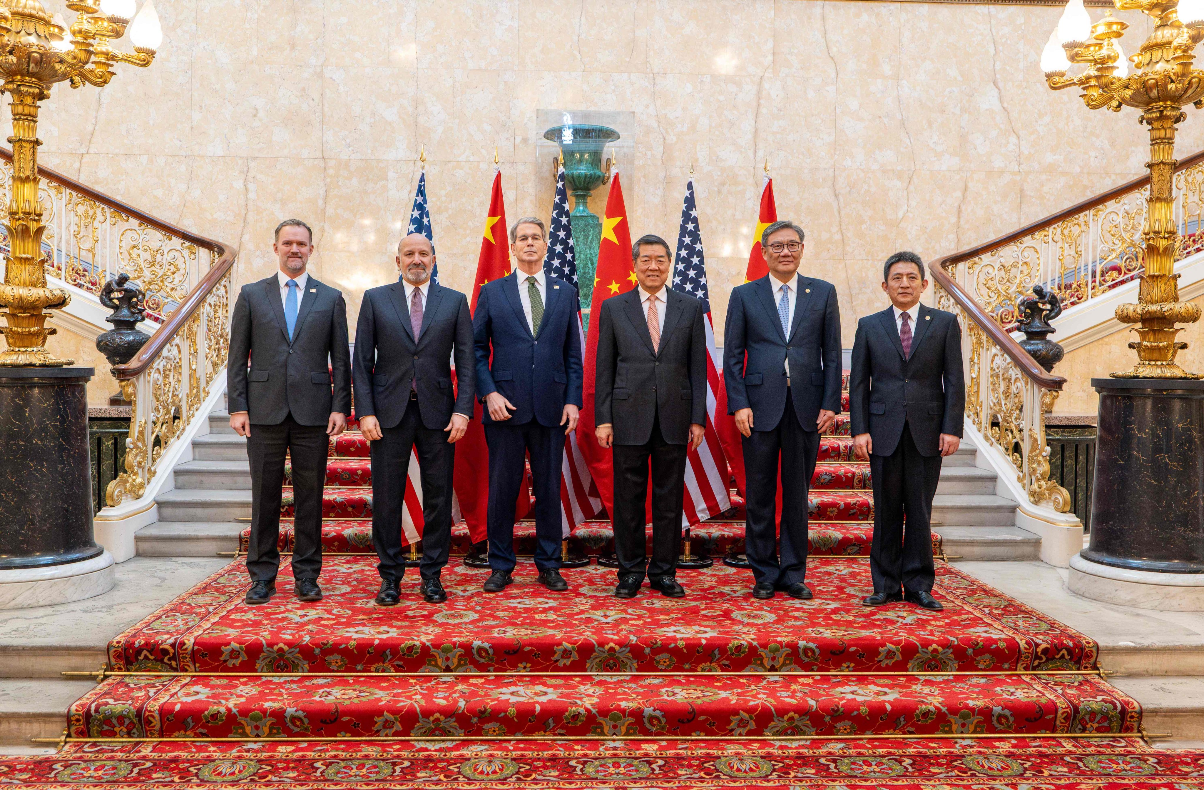 US and Chinese economic officials pose for a photo before the start of trade talks in Lancaster House in London on Monday. Photo: AFP
