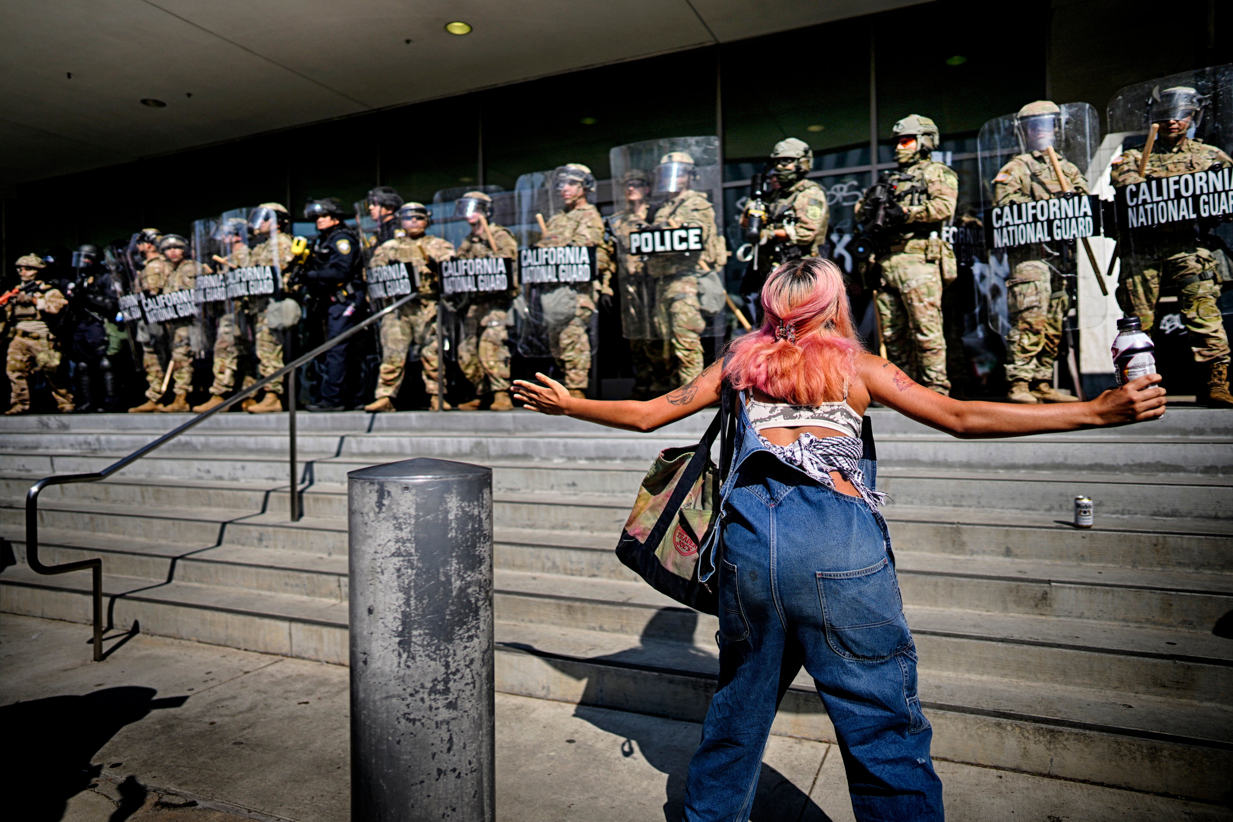A protester taunts a line of California National Guard protecting a federal building in downtown Los Angeles on Monday. Photo: AP