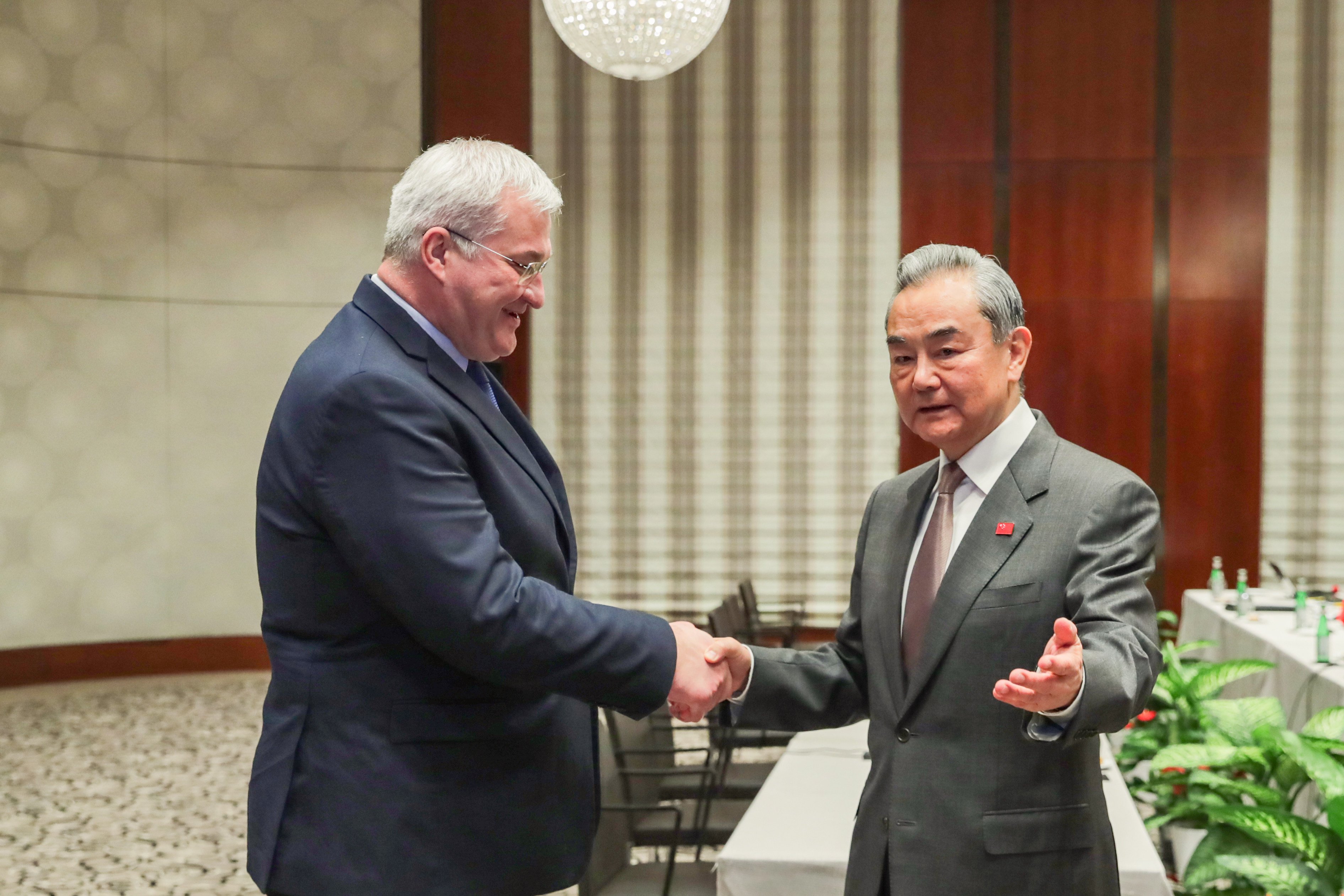 Foreign Minister Wang Yi, right, greets his Ukrainian counterpart Andrii Sybiha on the sidelines of the Munich Security Conference, in Munich, Germany, on February 15. Photo: Xinhua