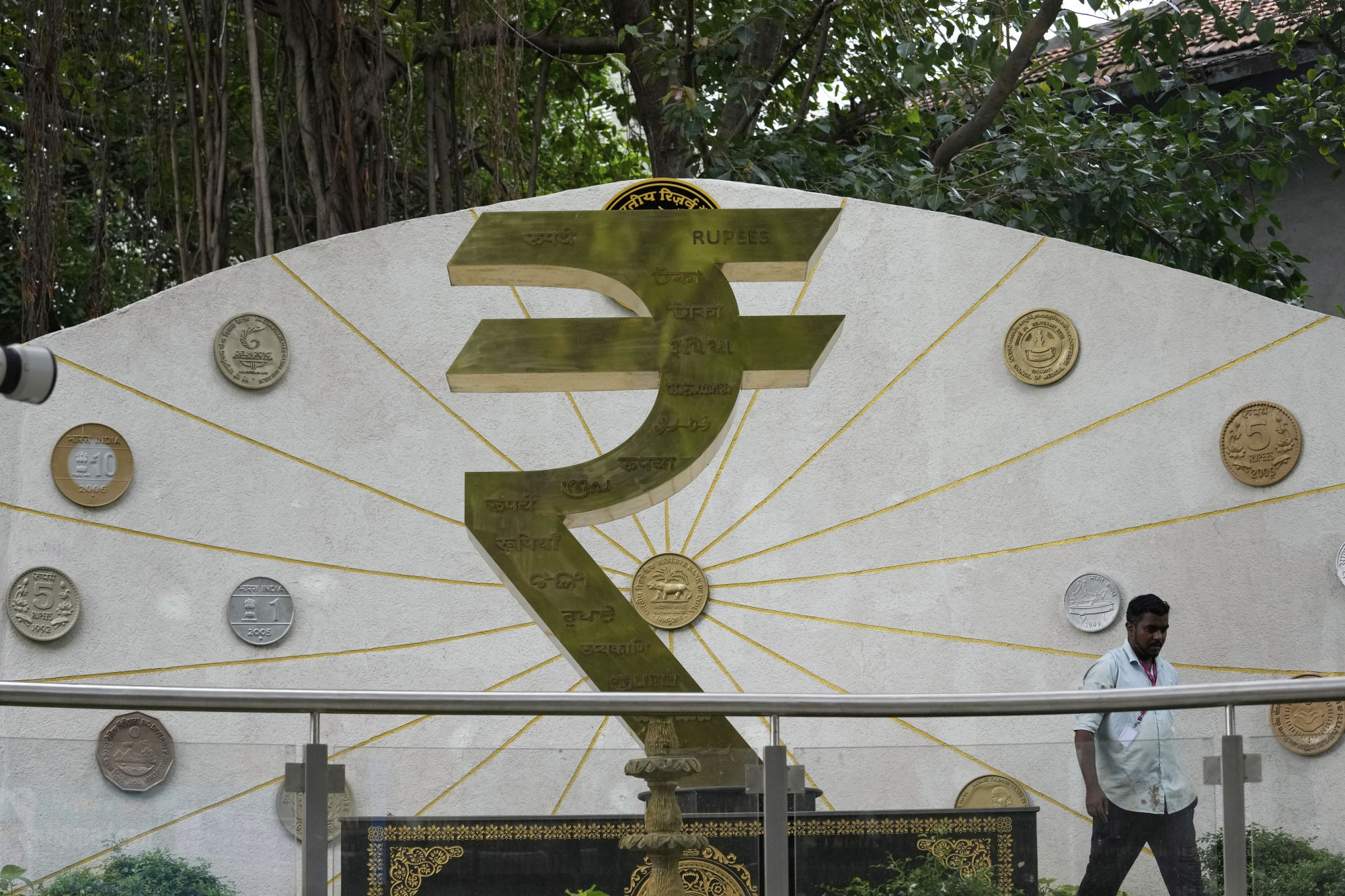 A man walks past the rupee symbol outside the Reserve Bank of India headquarters in Mumbai on June 6. The central bank last week delivered a larger-than-expected interest rate cut of 50 basis points. Photo: AP A man walks past the rupee symbol outside the Reserve Bank of India headquarters in Mumbai on June 6. The central bank last week delivered a larger-than-expected interest rate cut of 50 basis points. Photo: AP