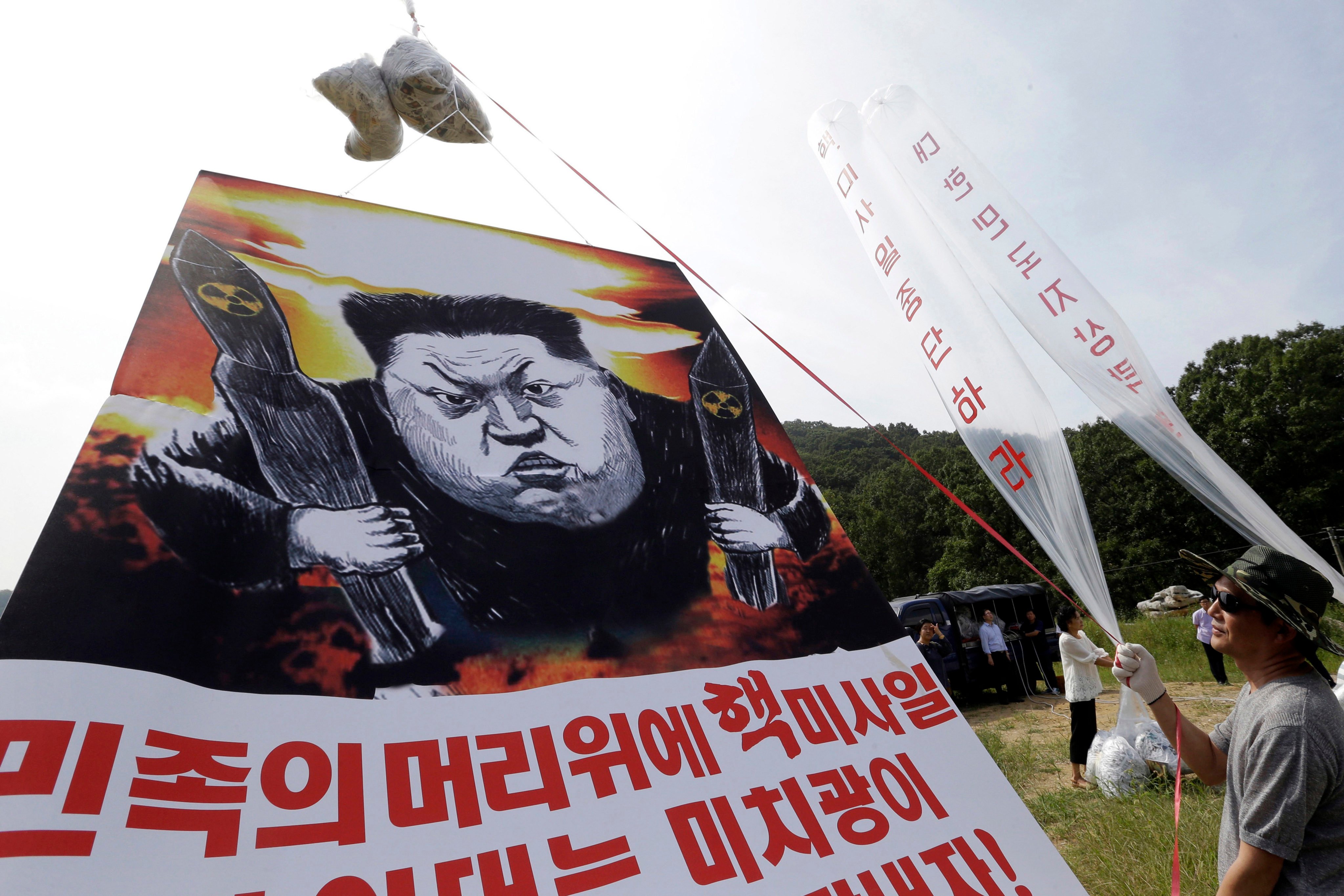 Balloons carrying leaflets and a banner denouncing North Korean leader Kim Jong-un being prepared for launch near the border between the two Koreas in 2016. Photo: AP