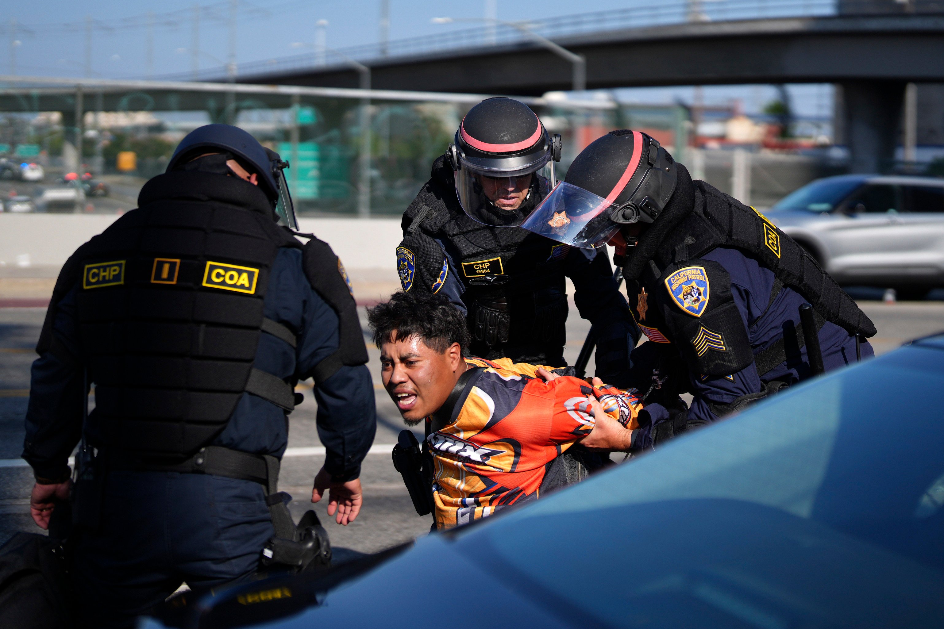 A protester is arrested by California Highway Patrol near the federal building in downtown Los Angeles on Tuesday. Photo: AP