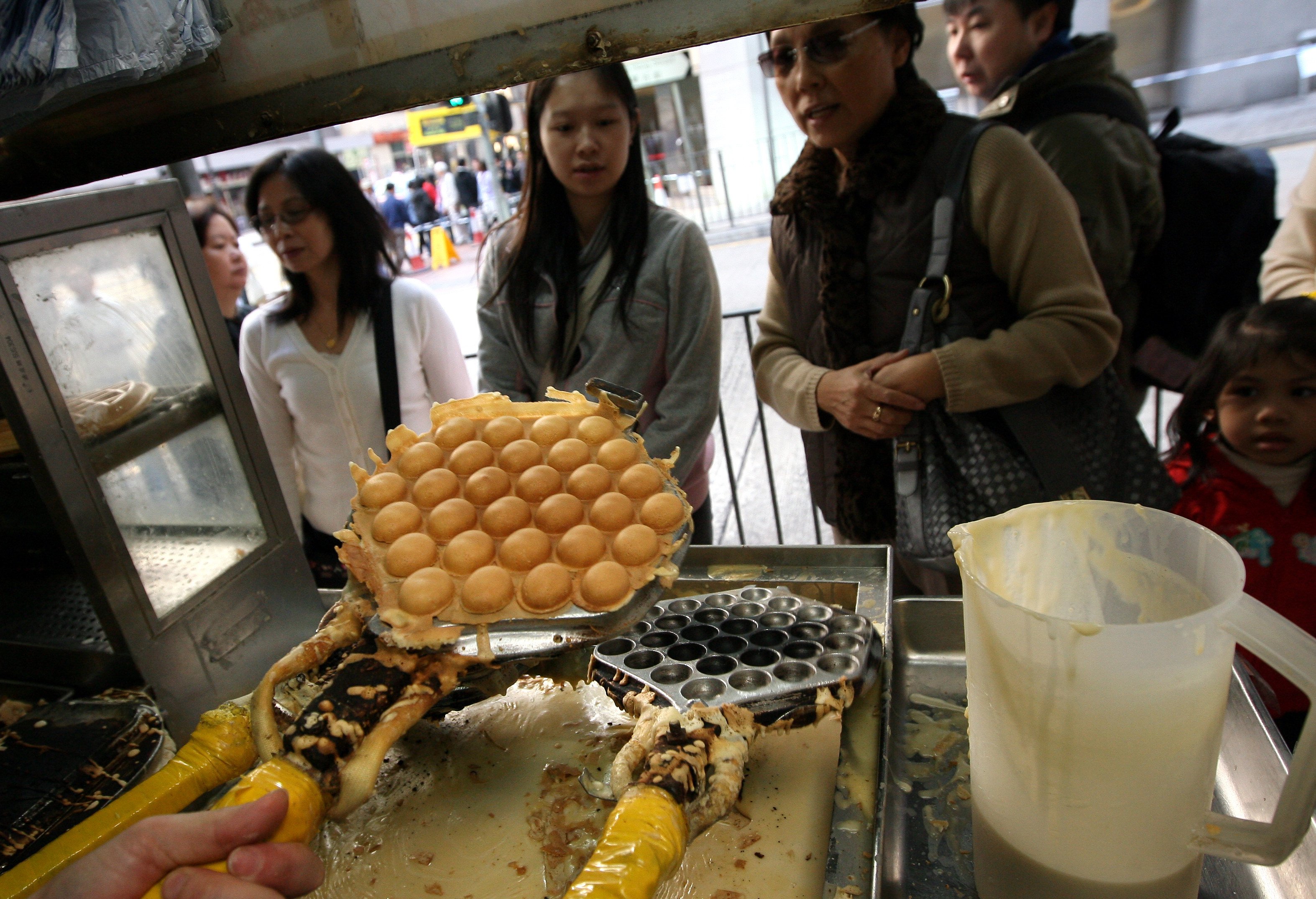 People queue to buy egg waffles at an egg waffle shop in North Point, Hong Kong. Photo: SCMP