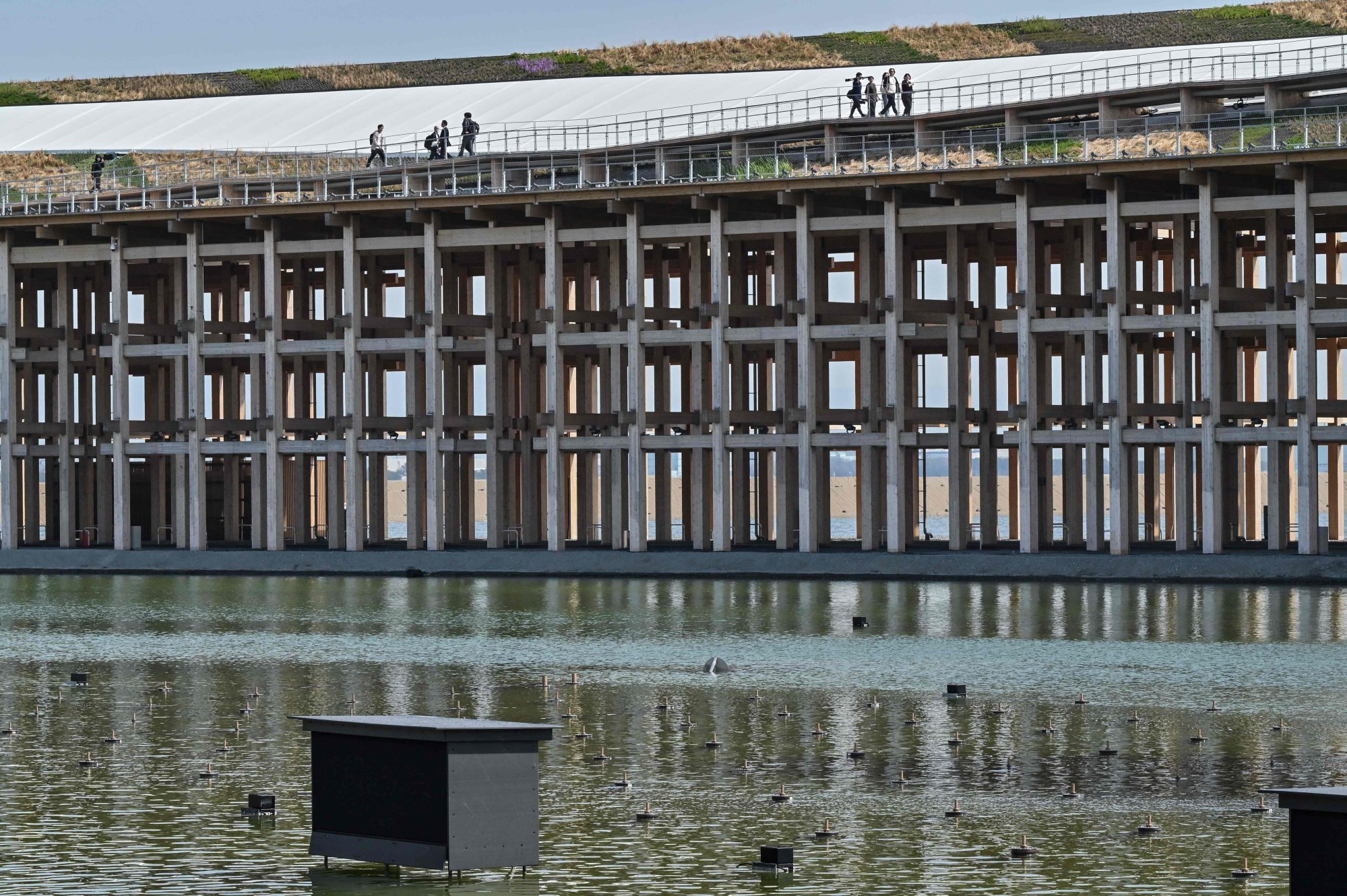 Visitors walking along the top of the wooden “Grand Ring” above the water. Photo: AFP Visitors walking along the top of the wooden “Grand Ring” above the water. Photo: AFP