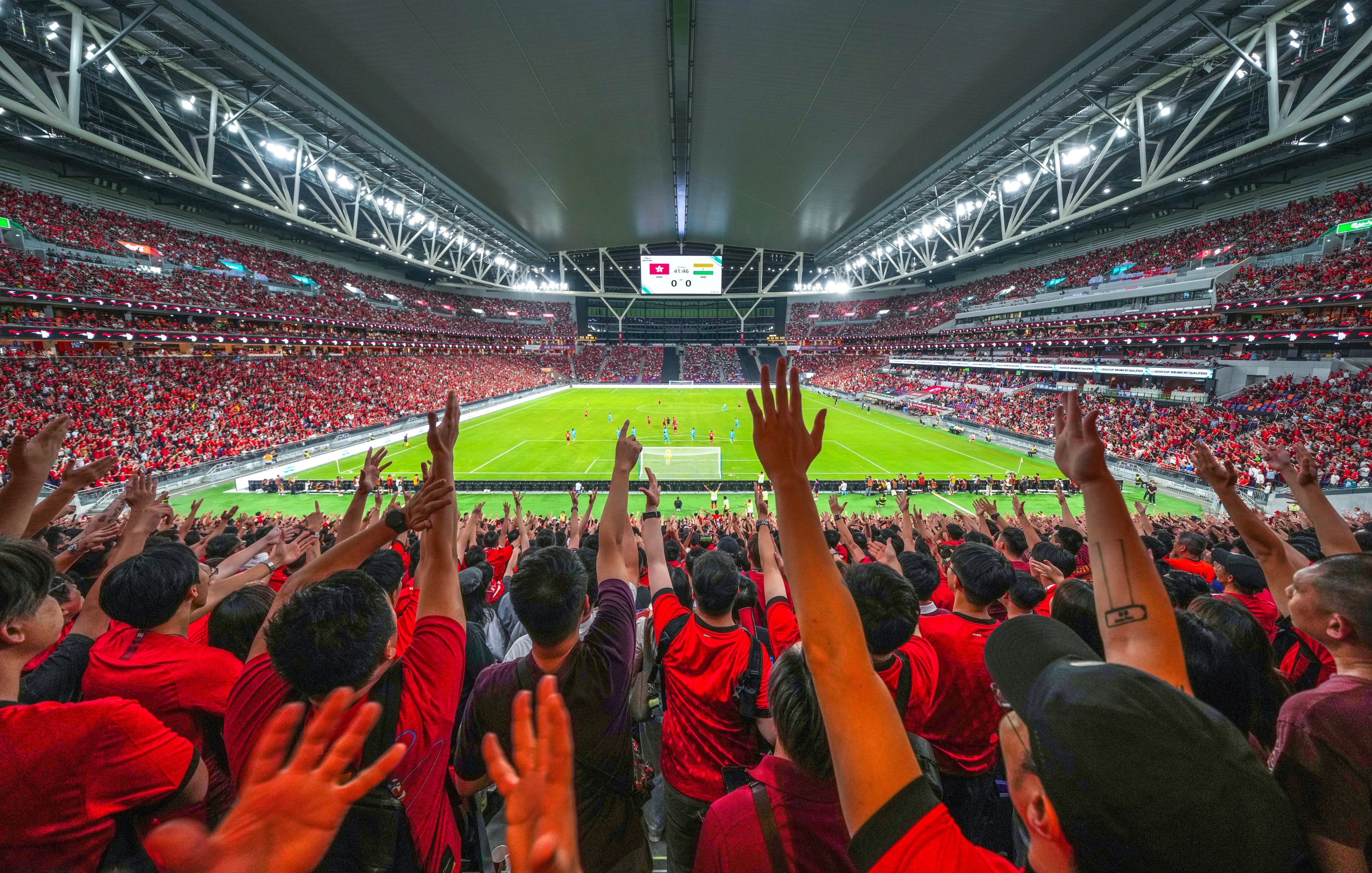 Hong Kong fans cheer for their team at Kai Tak Stadium on Tuesday. Photo: Sam Tsang