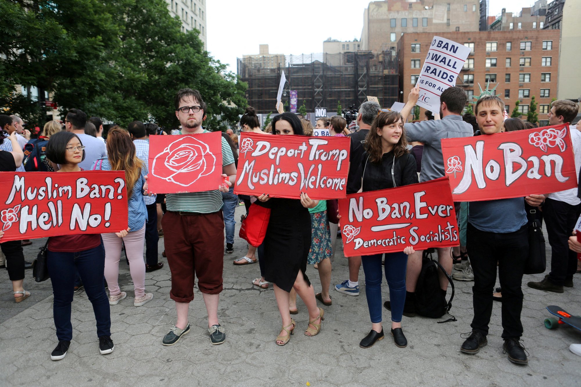 Protesters hold signs against US President Donald Trump’s travel ban. Photo: Reuters Protesters hold signs against US President Donald Trump’s travel ban. Photo: Reuters