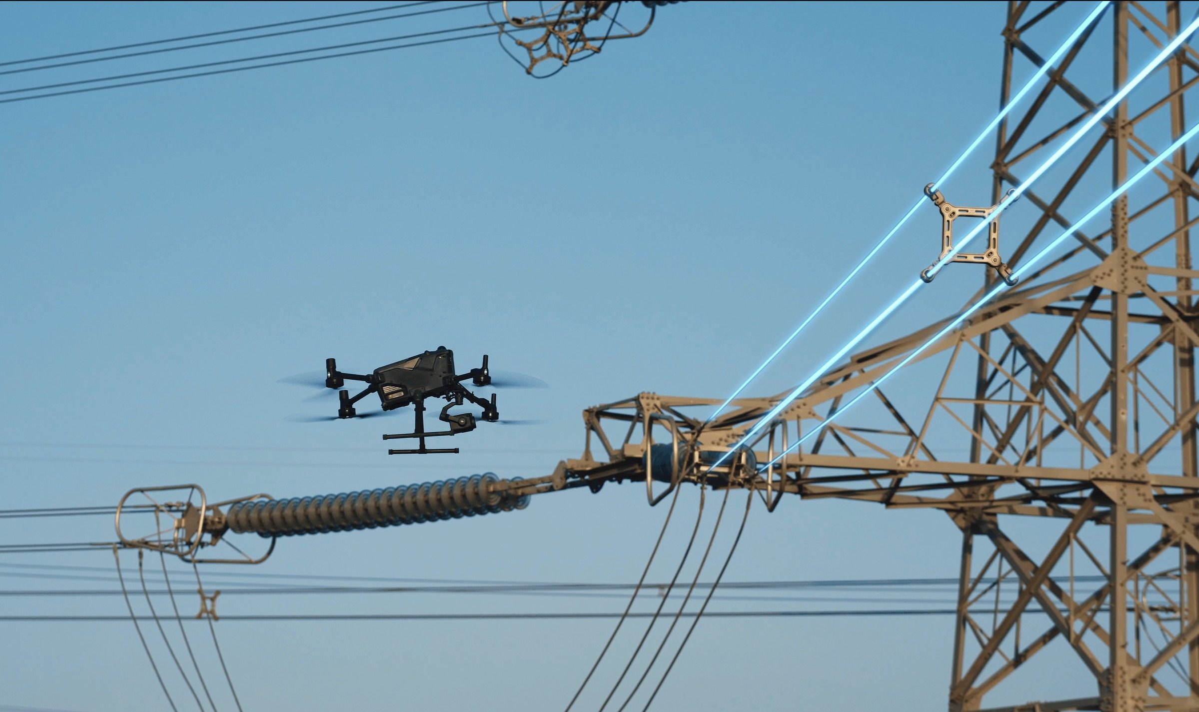 DJI’s Matrice 400 enterprise drone flies near a high-voltage transmission tower. Photo: Handout