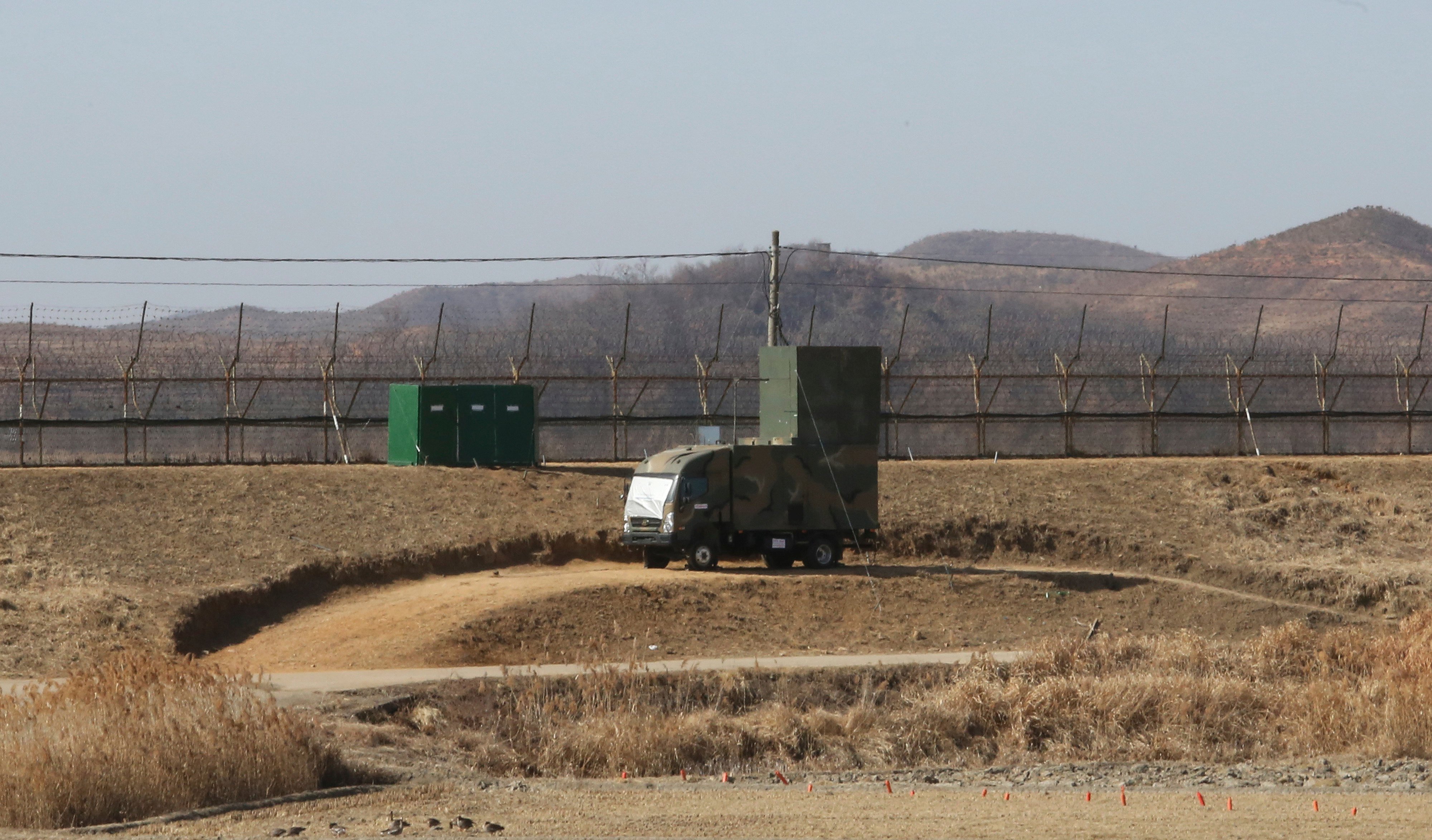 A South Korean military vehicle with loudspeakers is seen in front of a barbed-wire fence near the border with North Korea. Photo: AP