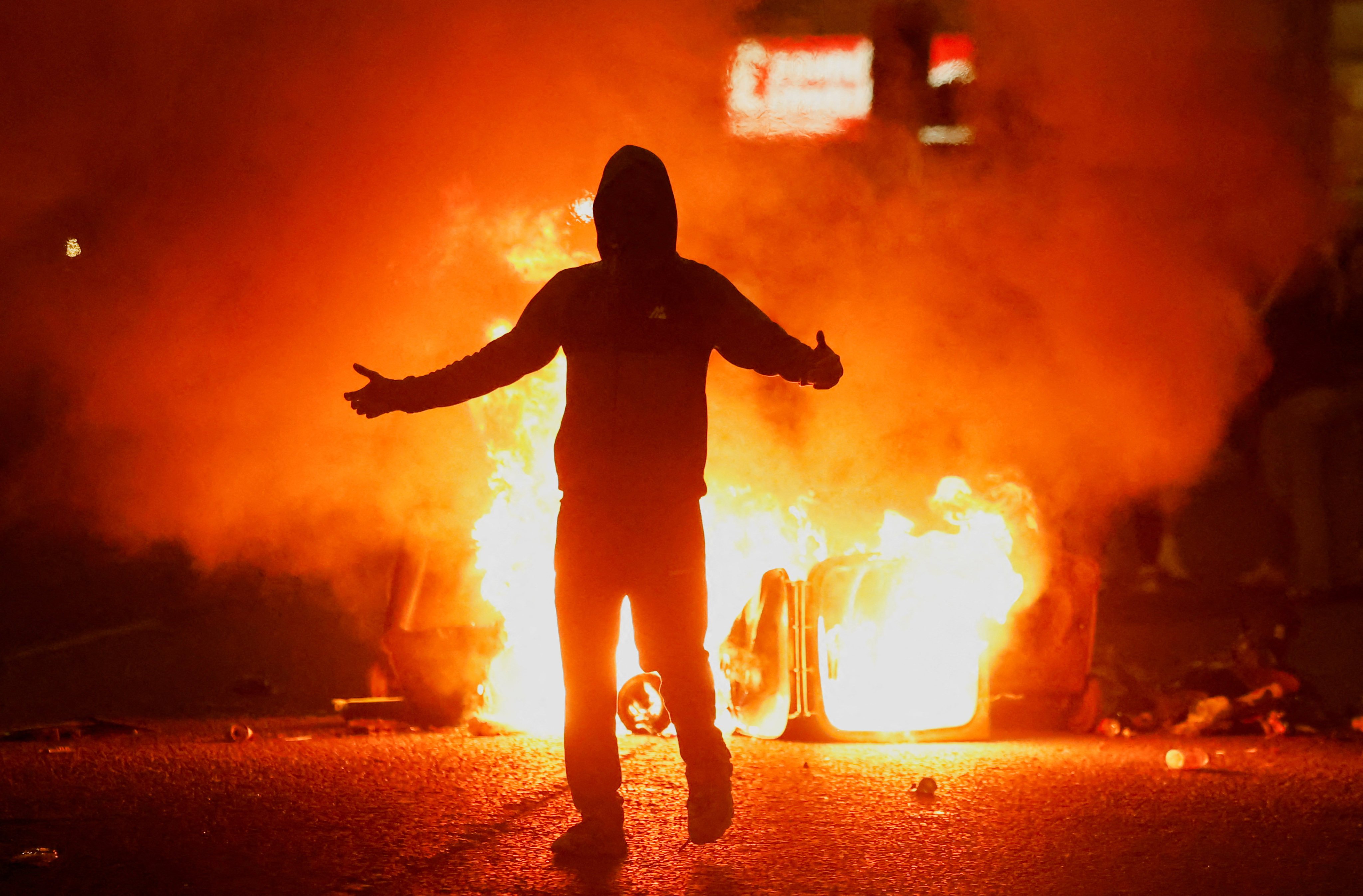 Fire burns near a demonstrator as riots continue in Ballymena, Northern Ireland, on June 11. Photo: Reuters