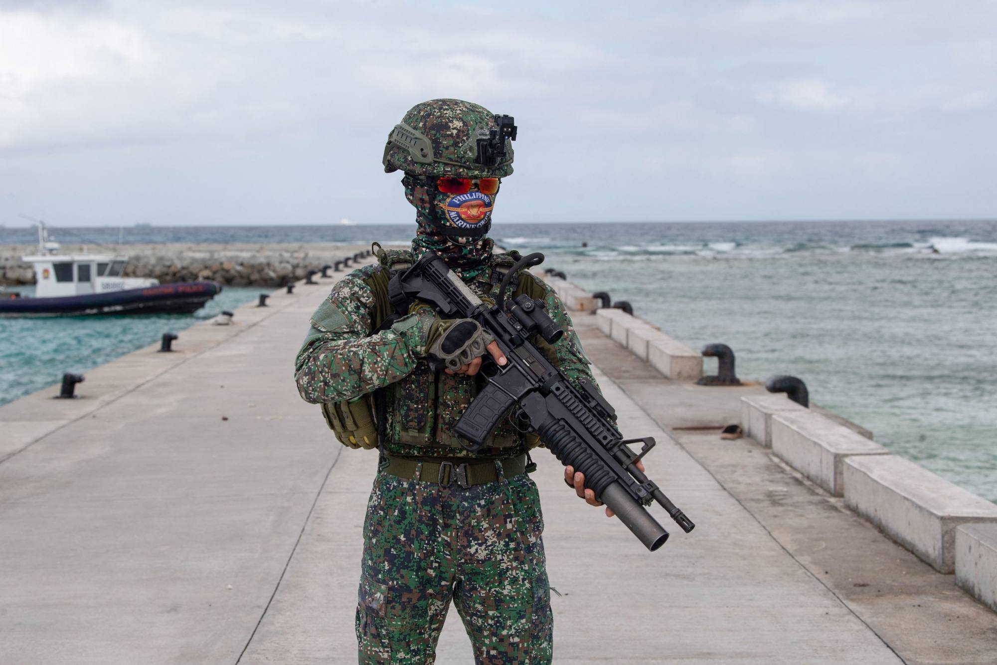A Philippine marine stands guard at a pier on Thitu Island in the disputed South China Sea on June 4. Photo: AFP A Philippine marine stands guard at a pier on Thitu Island in the disputed South China Sea on June 4. Photo: AFP
