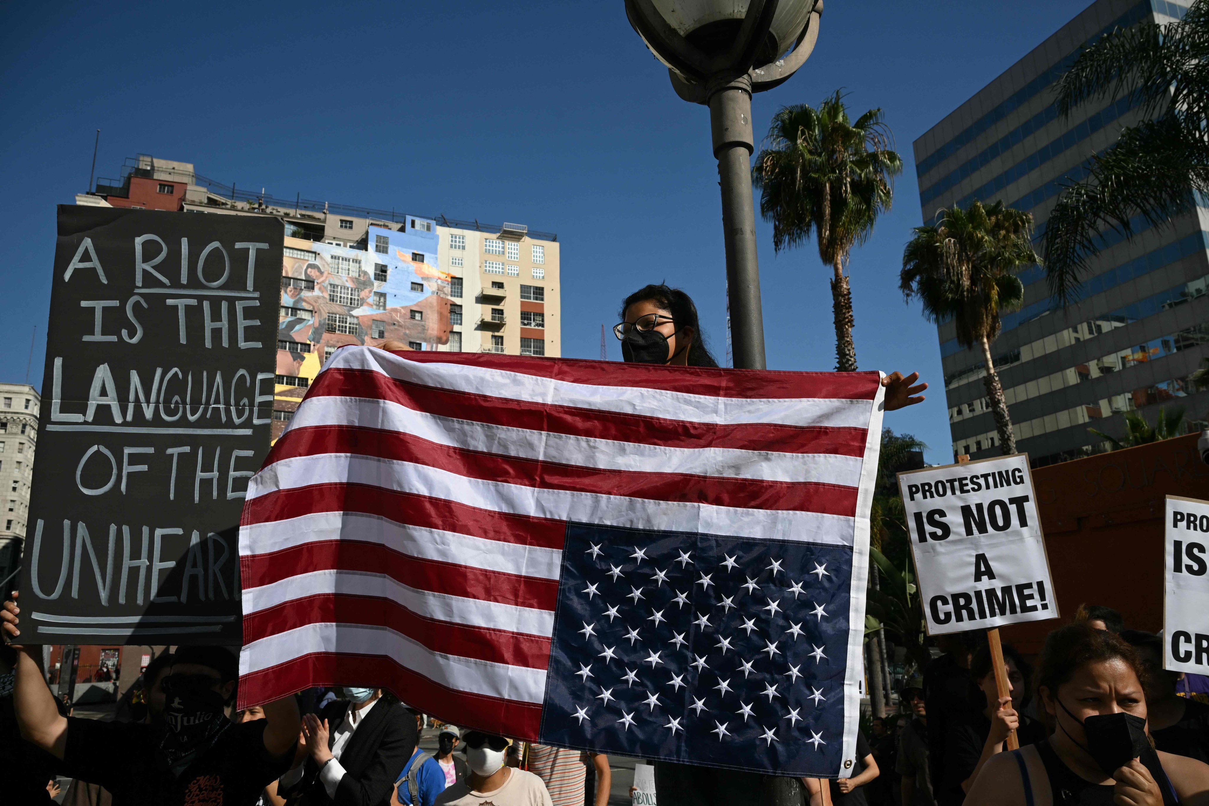 A protester holds an upside down US flag during a protest in downtown Los Angeles on Wednesday. Photo: AFP