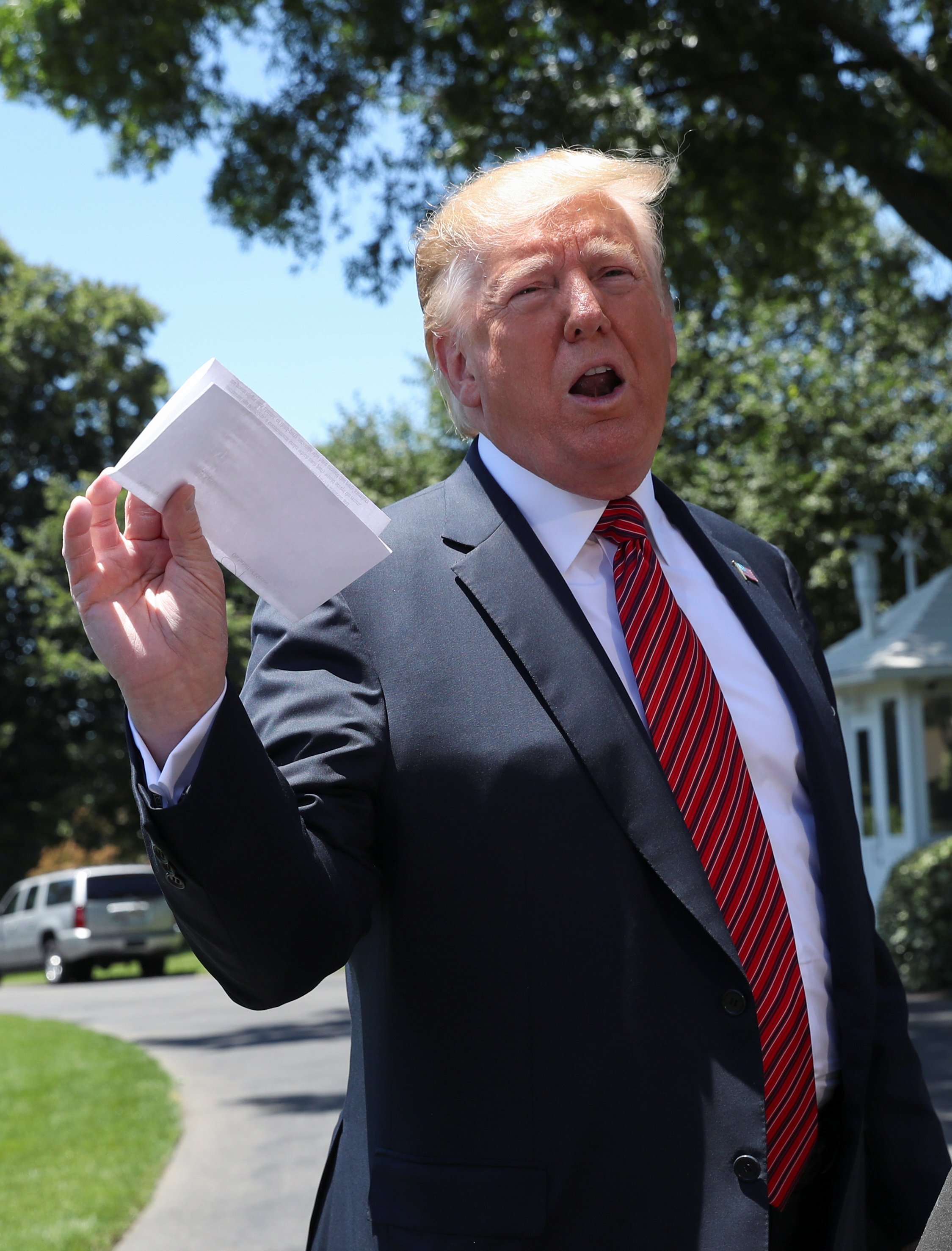 US President Donald Trump holds up what he described as a letter from North Korean leader Kim Jong-un outside the White House in June 2019. Photo: Reuters