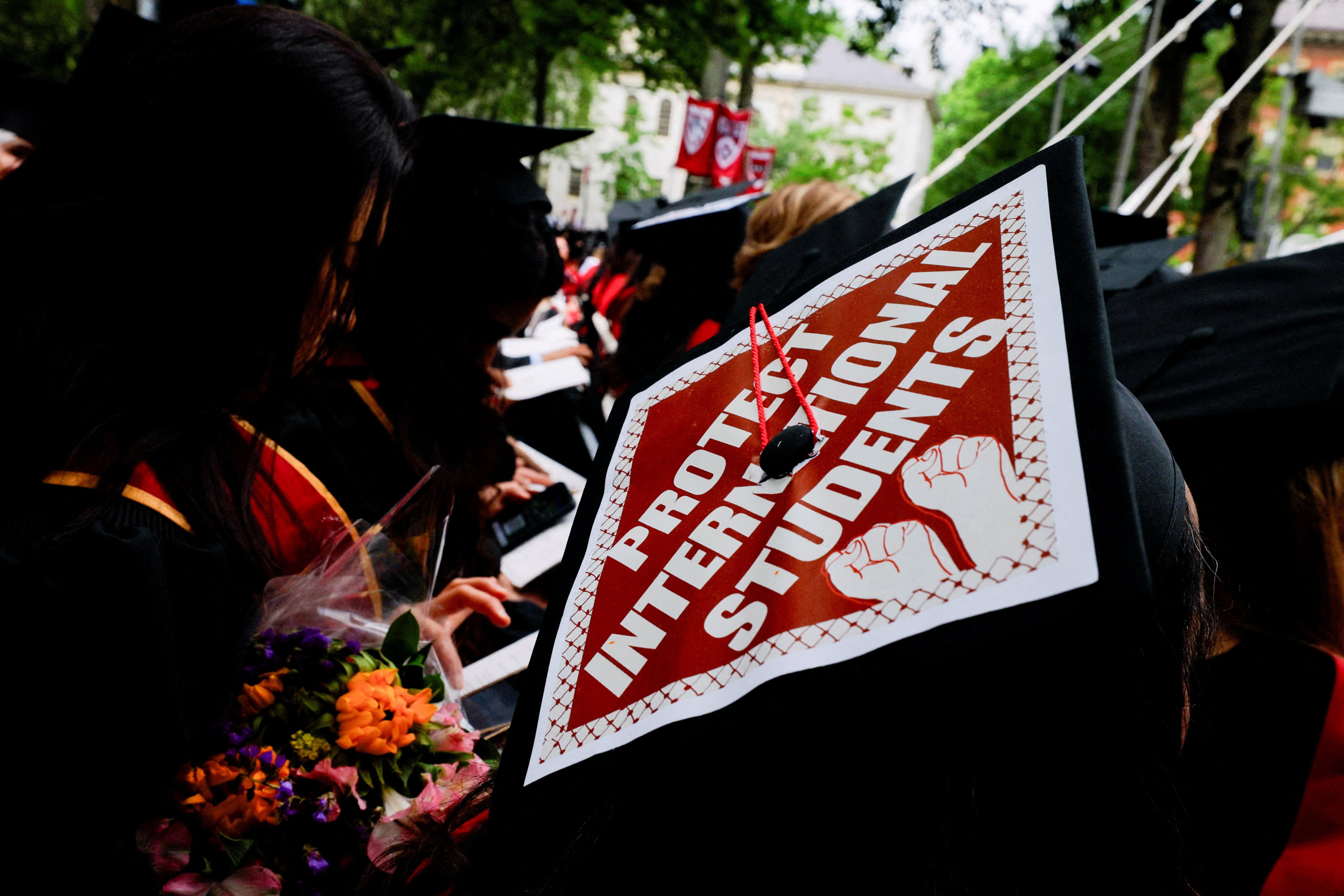 A student wears a graduation cap with a statement of support for international students at Harvard University in Cambridge, Massachusetts on May 29. Photo: Reuters