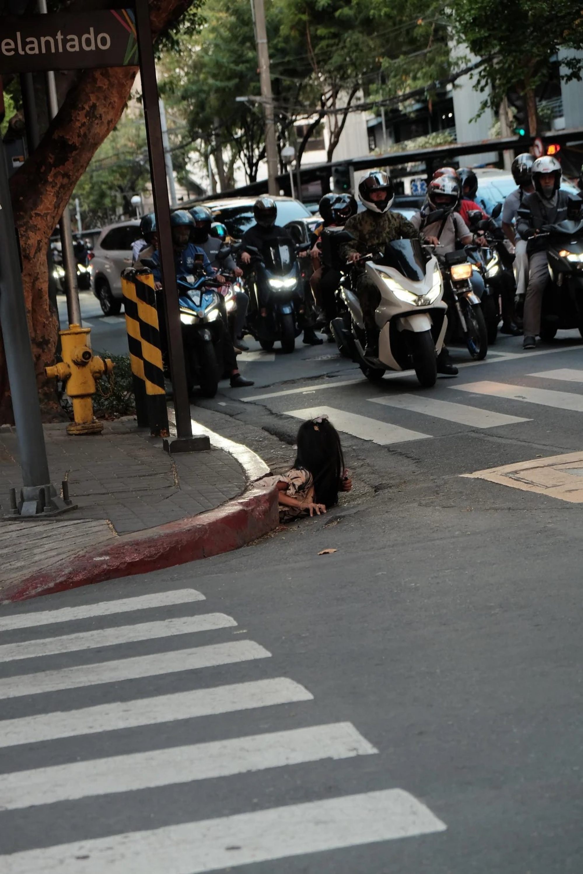 A woman is photographed emerging from a drainage hole along a street in Makati City. There are about 4.5 million homeless individuals in the Philippines, according to a 2023 study. Photo: William Roberts
