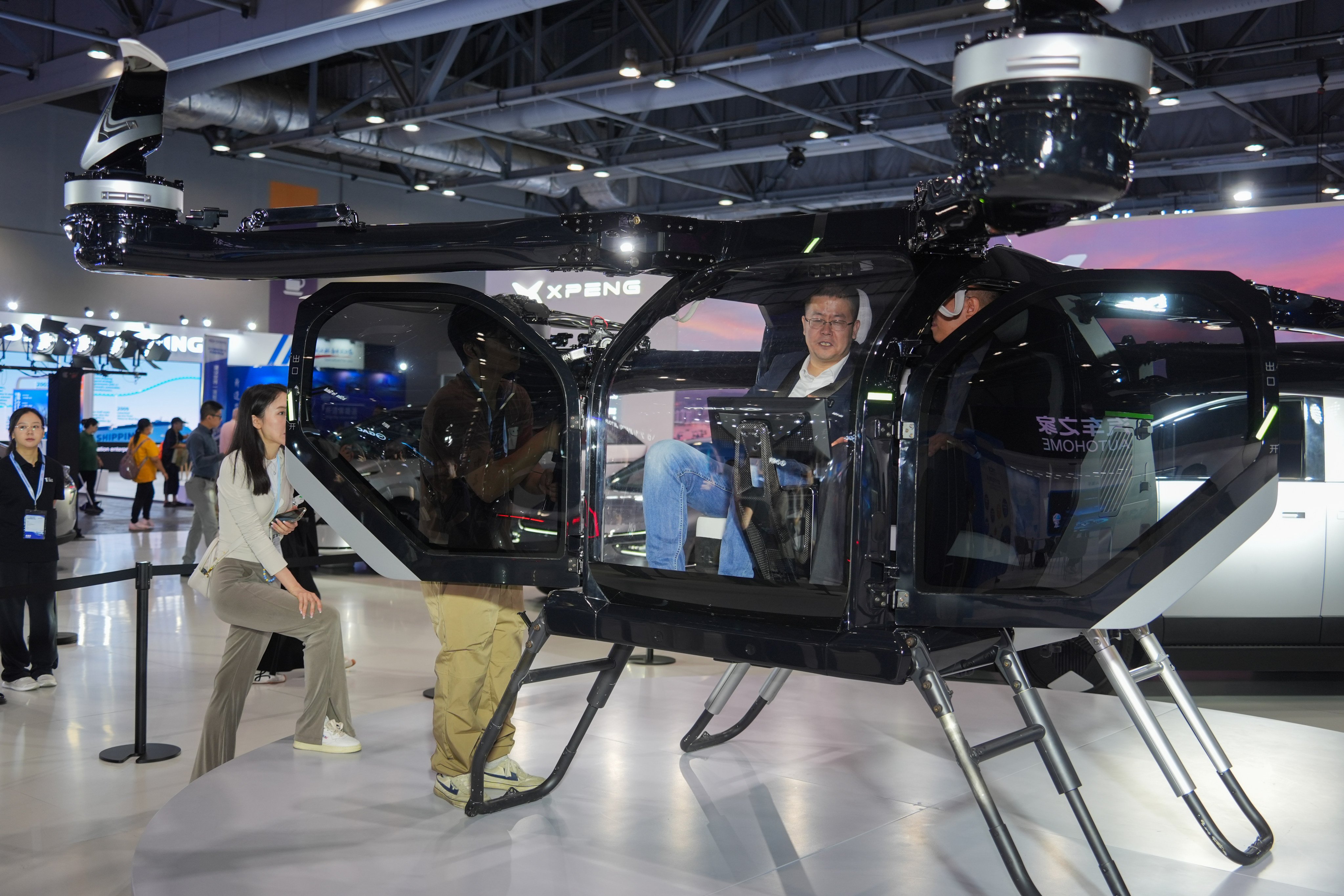 Visitors at Xpeng’s booth at the  Hong Kong International Automotive and Supply Chain Expo on Thursday. Photo: Eugene Lee
