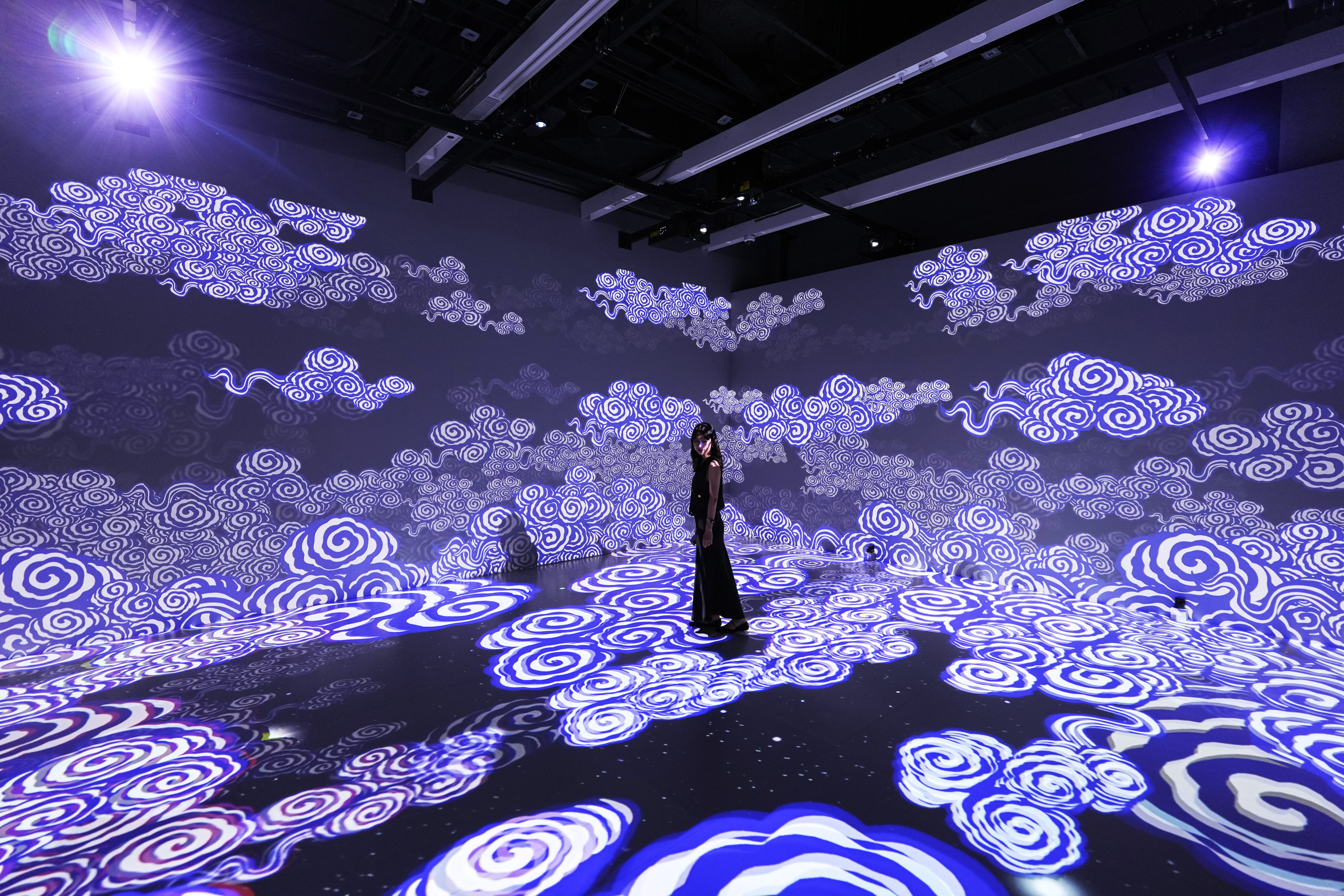 A projection of clouds is seen at the section, Profusion of Lights and Colours, part of “The Ways in Patterns: An Immersive Digital Exhibition from the Palace Museum”. Photo: Eugene Lee