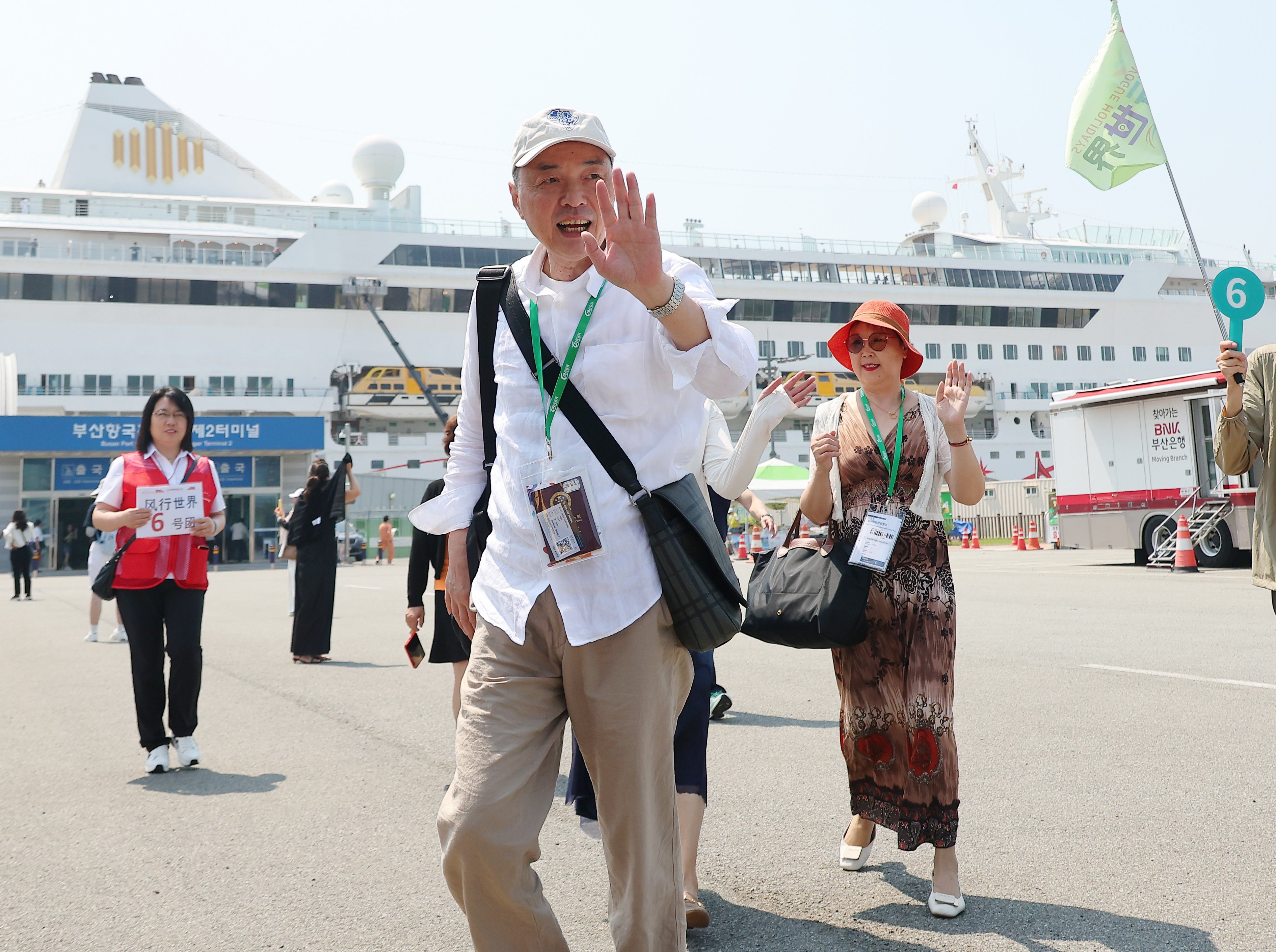 Chinese tourists wave after disembarking from the Blue Dream Melody cruise ship in Busan, South Korea, in June last year. Photo: EPA-EFE/Yonhap