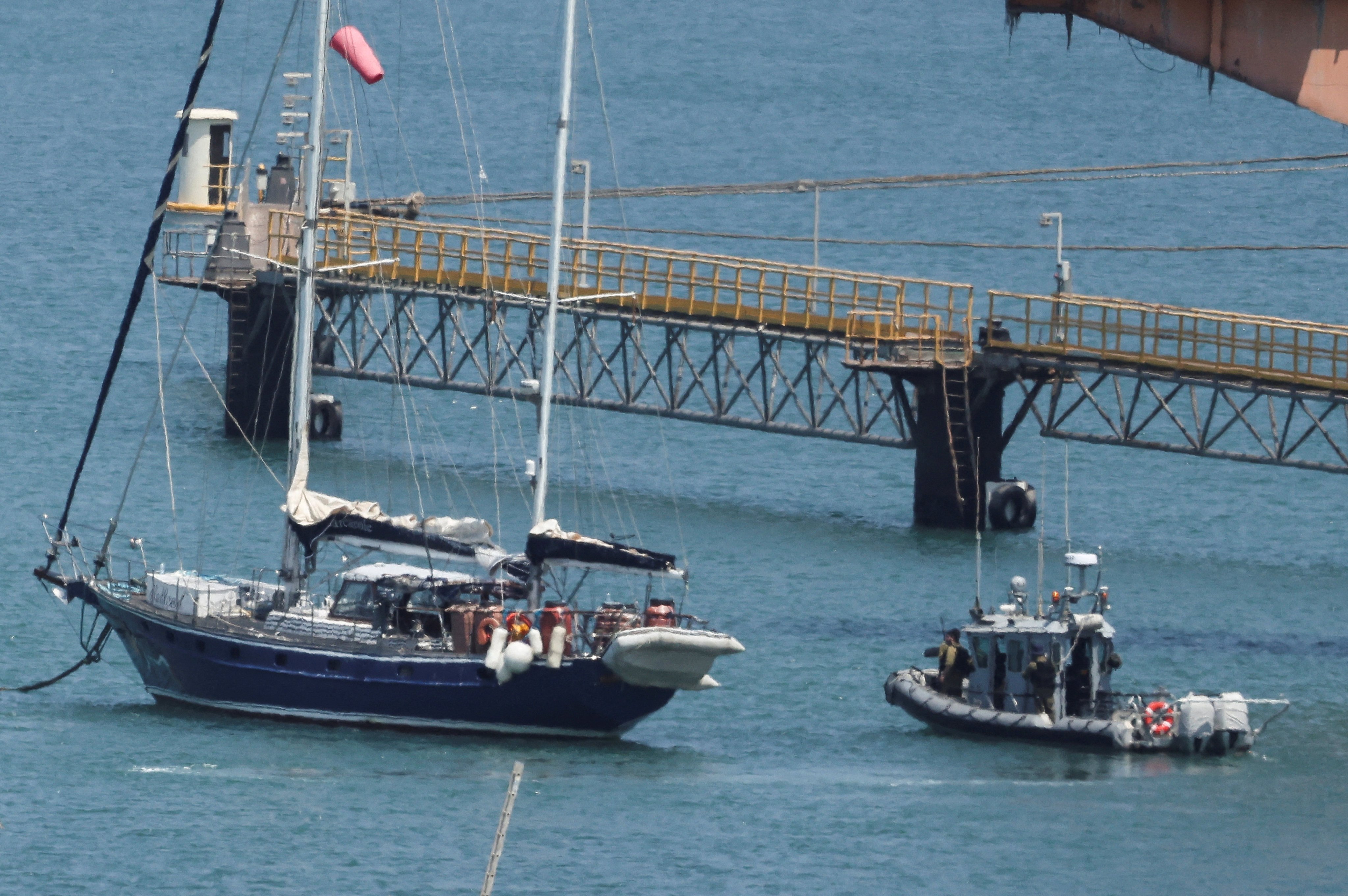 Gaza-bound yacht Madleen is seen docked next to a military boat in the port of Ashdod on Tuesday following a takeover by the Israeli army. Photo: Reuters