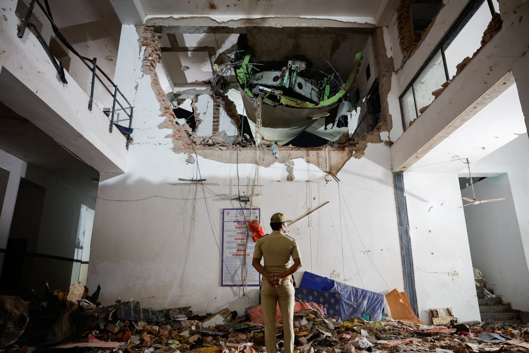 A police officer stands in front of the wreckage of the ill-fated plane. Photo: Reuters A police officer stands in front of the wreckage of the ill-fated plane. Photo: Reuters