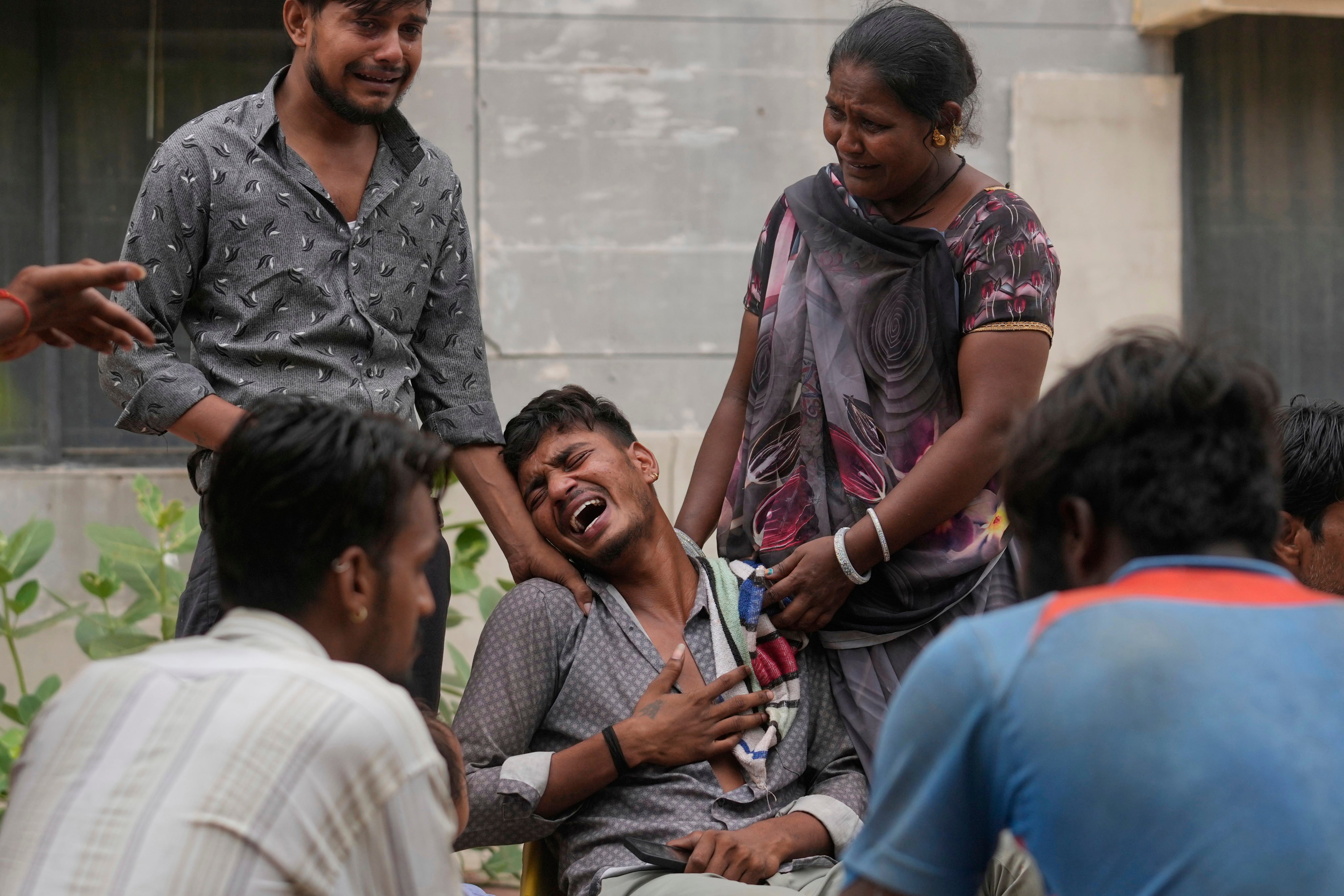 Kalpeshbhai Patni, whose 14-year-old brother was killed when an Air India plane crashed into a neighbourhood, wails outside a hospital in Ahmedabad. Photo: AP