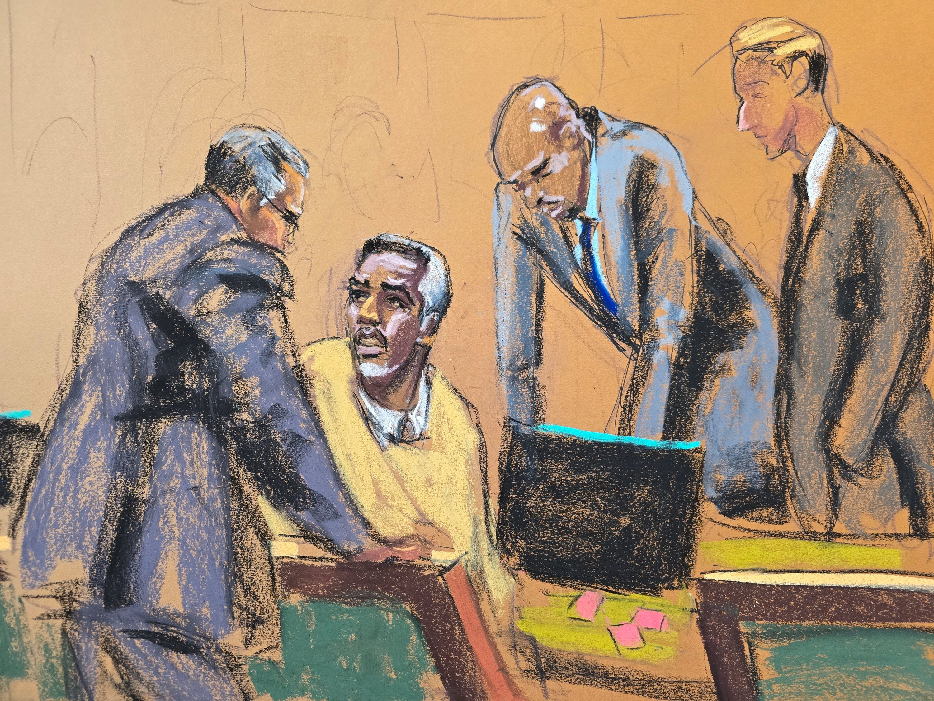 Sean “Diddy” Combs, seated, confers with his lawyers after a meeting with the judge during his sex trafficking trial in New York on Thursday in a courtroom sketch. Photo: Reuters