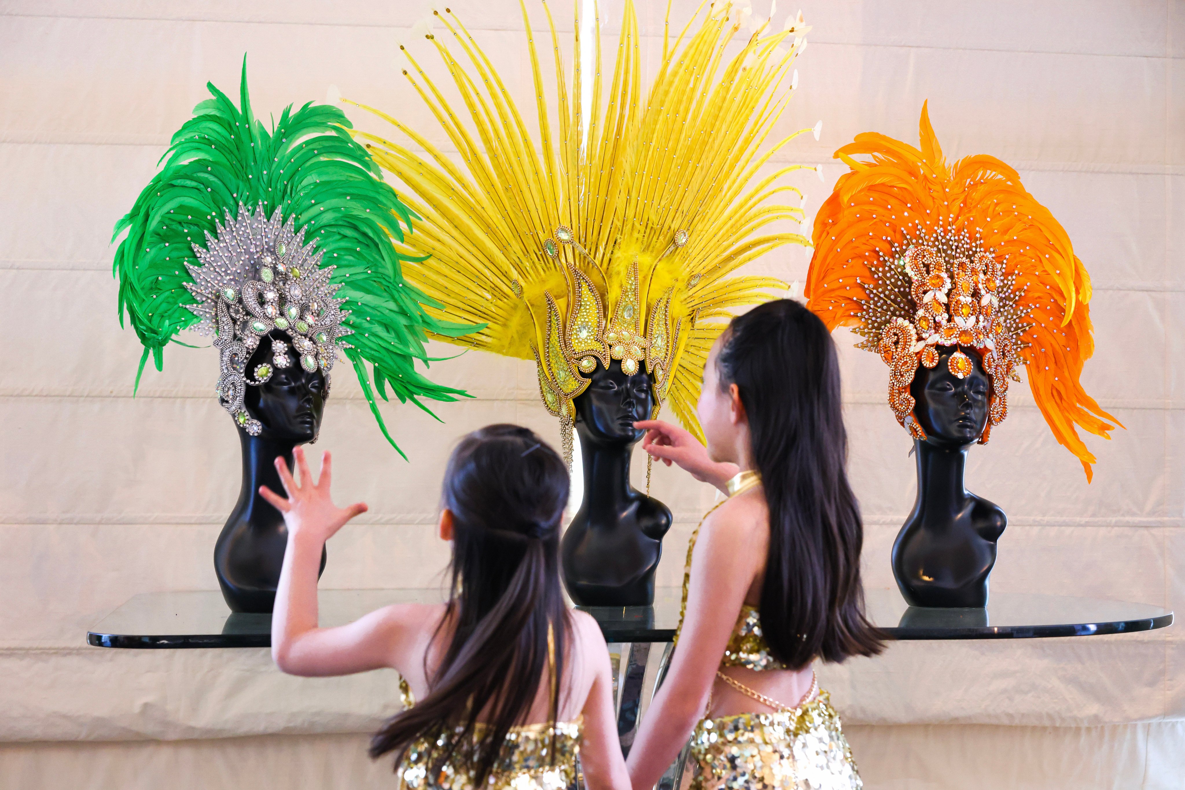 Young students of the SDM dance school admire extravagant samba headdresses for Hong Kong’s first-ever Brazilian festival, which comes to the city for 10 days from June 20-29. Photo: Nora Tam