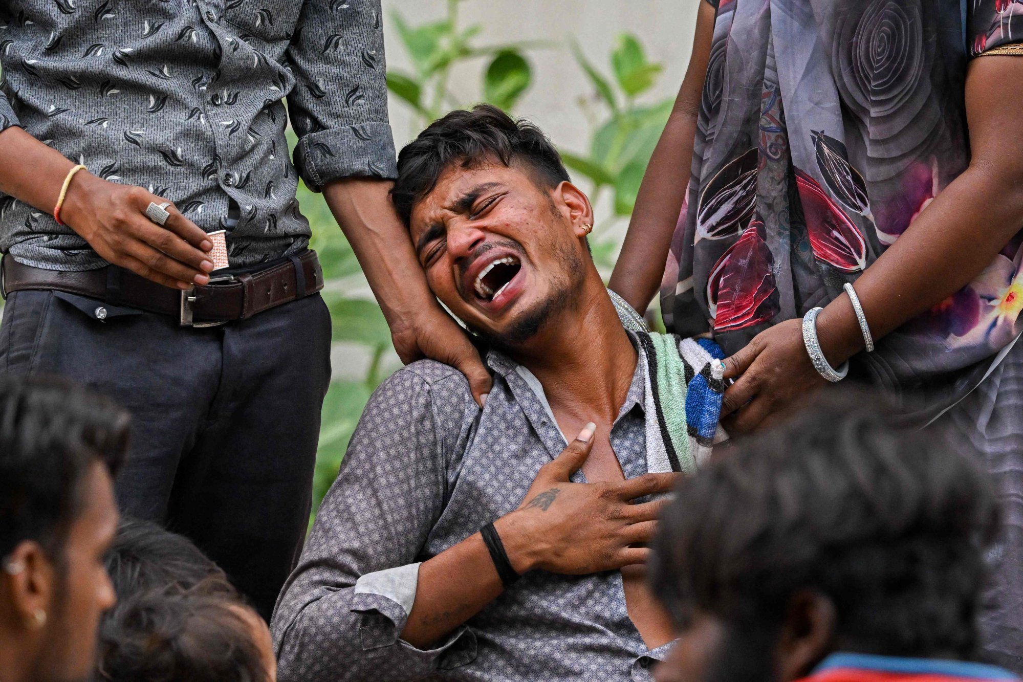 A man mourns the death of his brother, who was sleeping on the ground when an Air India flight crashed into a residential area, at a hospital mortuary in Ahmedabad on Friday. Photo: AFP A man mourns the death of his brother, who was sleeping on the ground when an Air India flight crashed into a residential area, at a hospital mortuary in Ahmedabad on Friday. Photo: AFP
