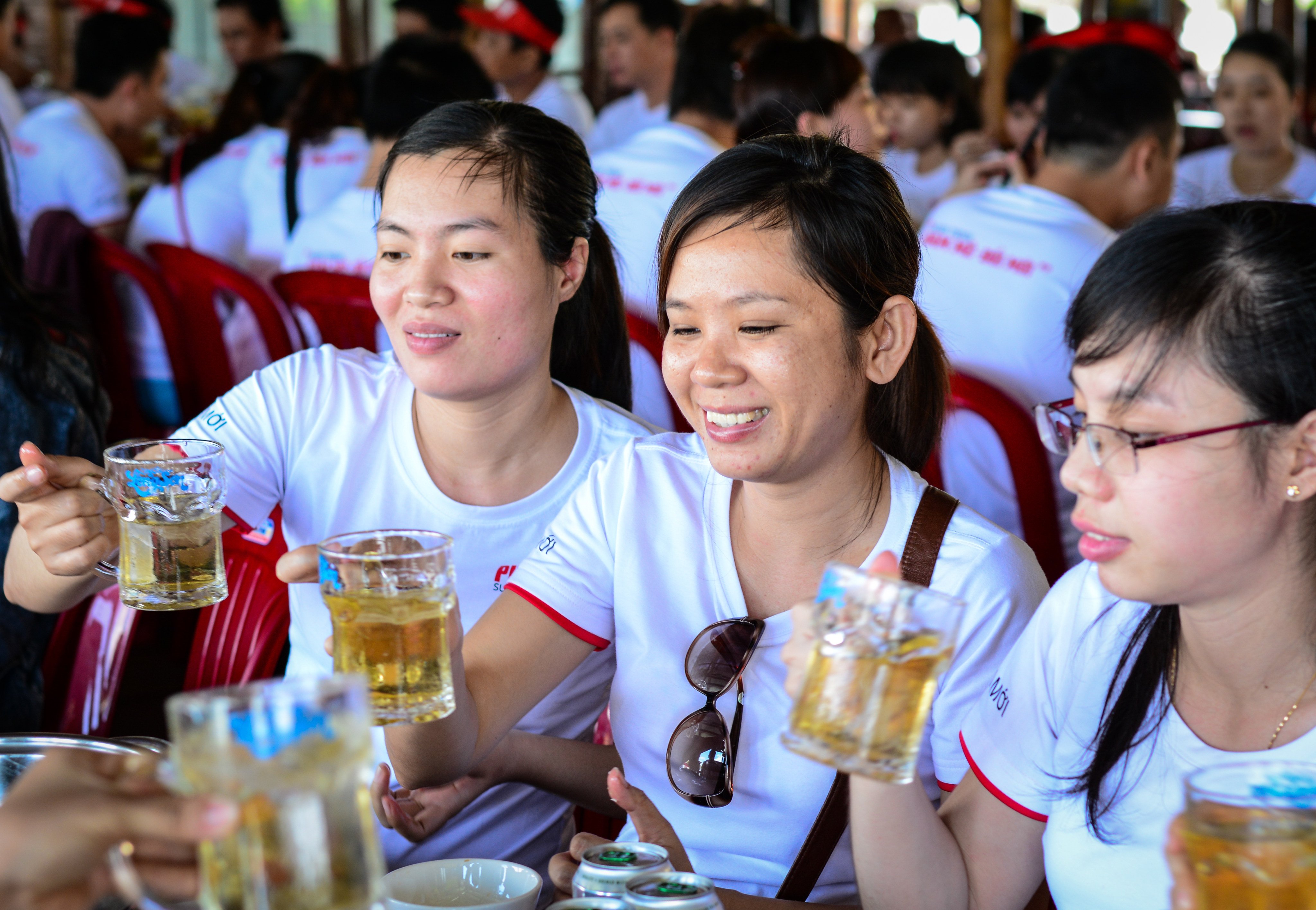 Young women drink beer at local restaurant in Saigon, Vietnam. Photo: Shutterstock