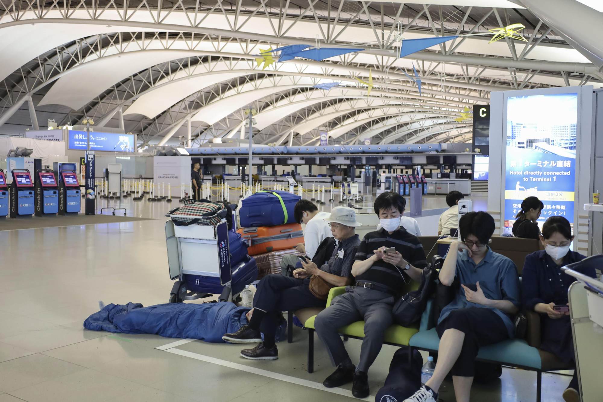 Passengers wait for the resumption of flights at Kansai airport after public transport was halted due to Typhoon Lan in 2023. Photo: Kyodo Passengers wait for the resumption of flights at Kansai airport after public transport was halted due to Typhoon Lan in 2023. Photo: Kyodo